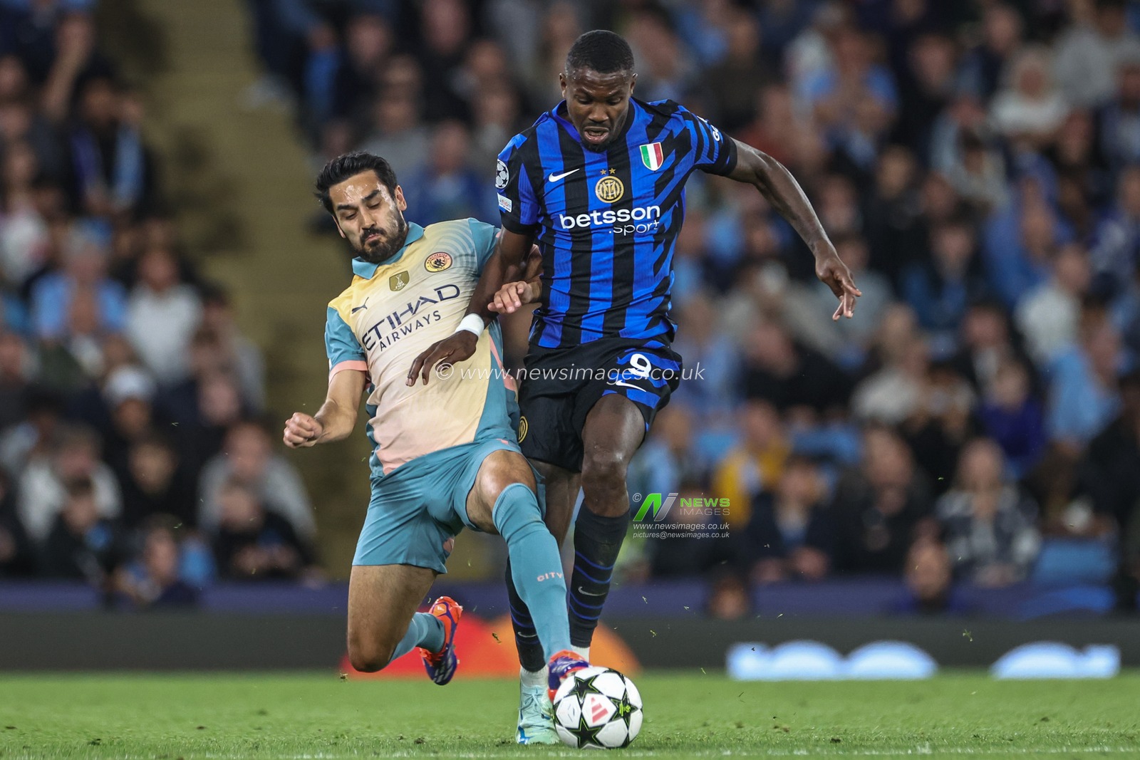 Ä°lkay GÃ¼ndoÄŸan of Manchester City slides in to tackle Marcus Thuram of Inter Milan who breaks away during the UEFA Champions League league stage match Manchester City vs Inter Milan at Etihad Stadium, Manchester, United Kingdom, 18th September 2024

(Photo by Mark Cosgrove/News Images)
