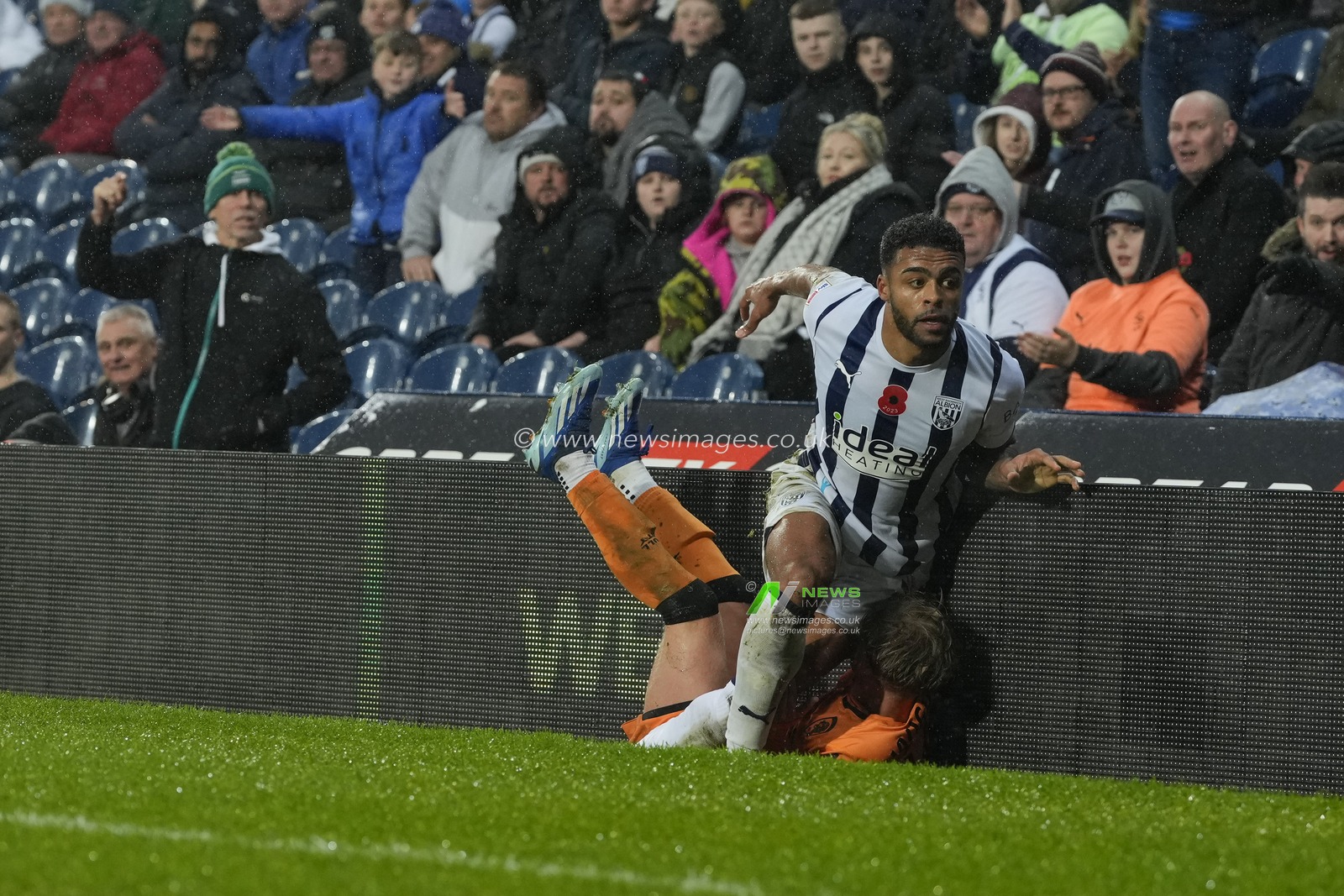 Darnell Furlong #2 of West Bromwich Albion pushes Harry Vaughan #14 of Hull City into the pitch side advertising boards  during the Sky Bet Championship match West Bromwich Albion vs Hull City at The Hawthorns, West Bromwich, United Kingdom, 4th November 2023

(Photo by Steve Flynn/News Images)