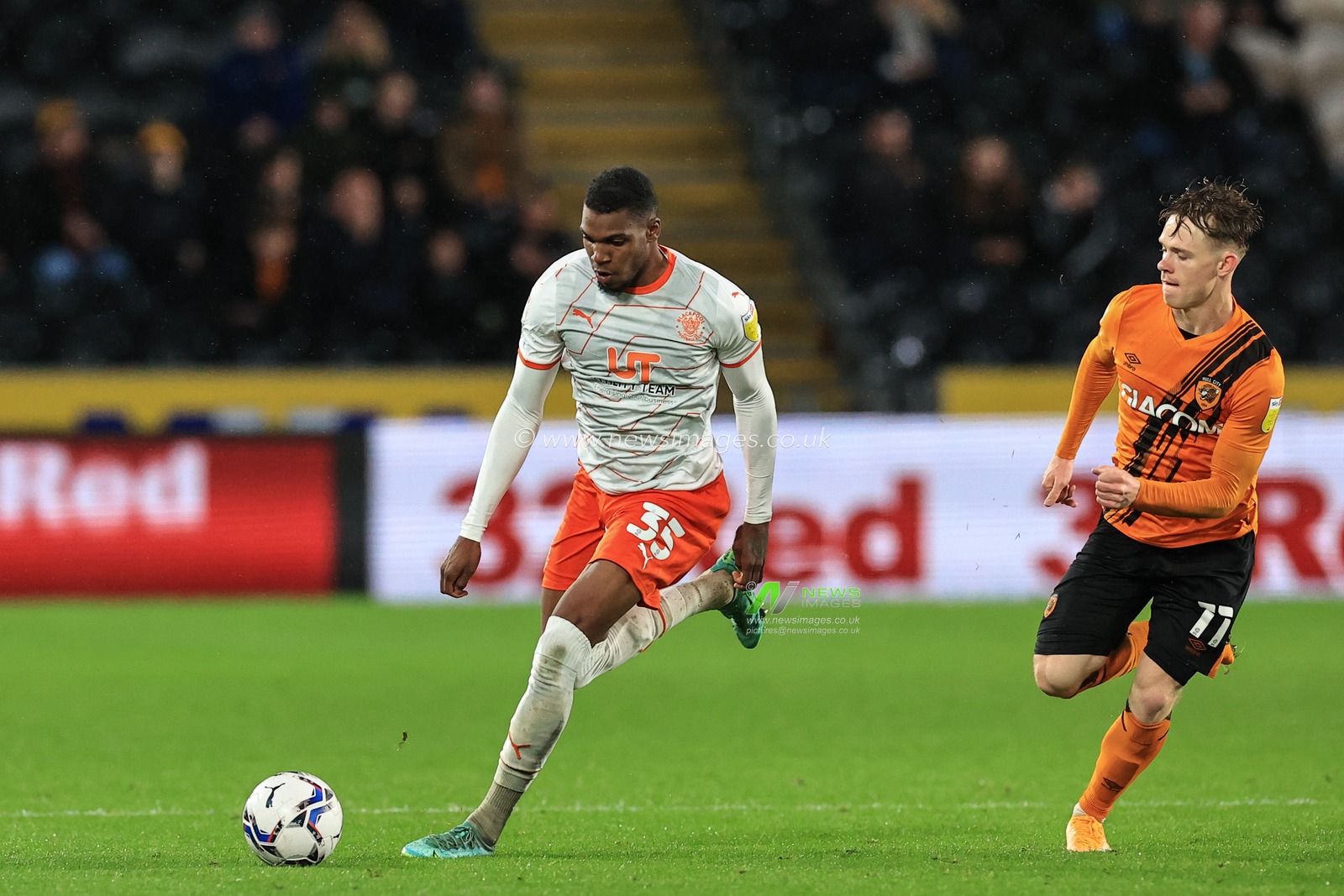 Dujon Sterling #35 of Blackpool breaks away from Keane Lewis-Potter #11 of Hull City