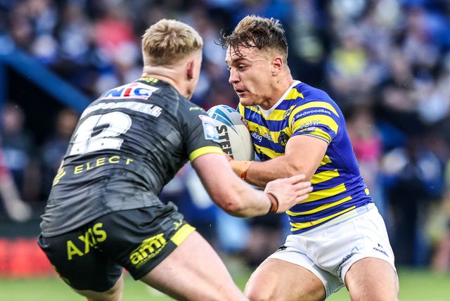 Leon Hayes of Warrington Wolves is tackled by James McDonnell of Leeds Rhinos during the Betfred Super League round 15 match Warrington Wolves vs Leeds Rhinos at The Halliwell Jones Stadium, Warrington, United Kingdom on 18 June 2026

(Photo by Alfie Cosgrove/News Images)