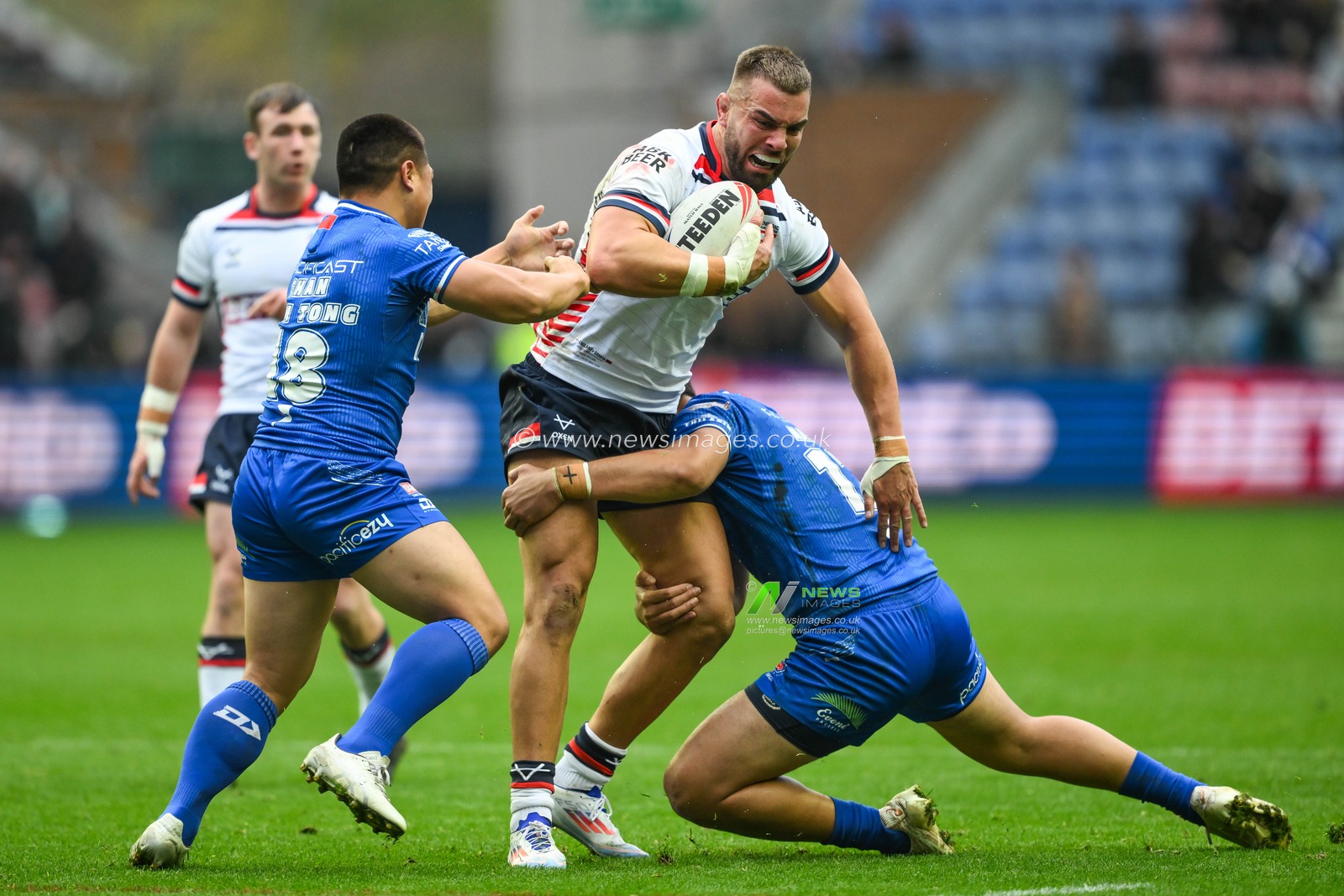 Mike McMeeken of England is tackled by Gordon Chan Kum Tong and Jeremiah Nanai of Samoa  during the ABK Beer Internationals Series match England vs Samoa at The Brick Community Stadium, Wigan, United Kingdom, 27th October 2024

(Photo by Craig Thomas/News Images)