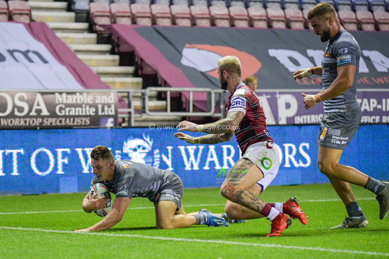 Tom Davies (2) of Catalans Dragons goes over for a try to make it 6-4