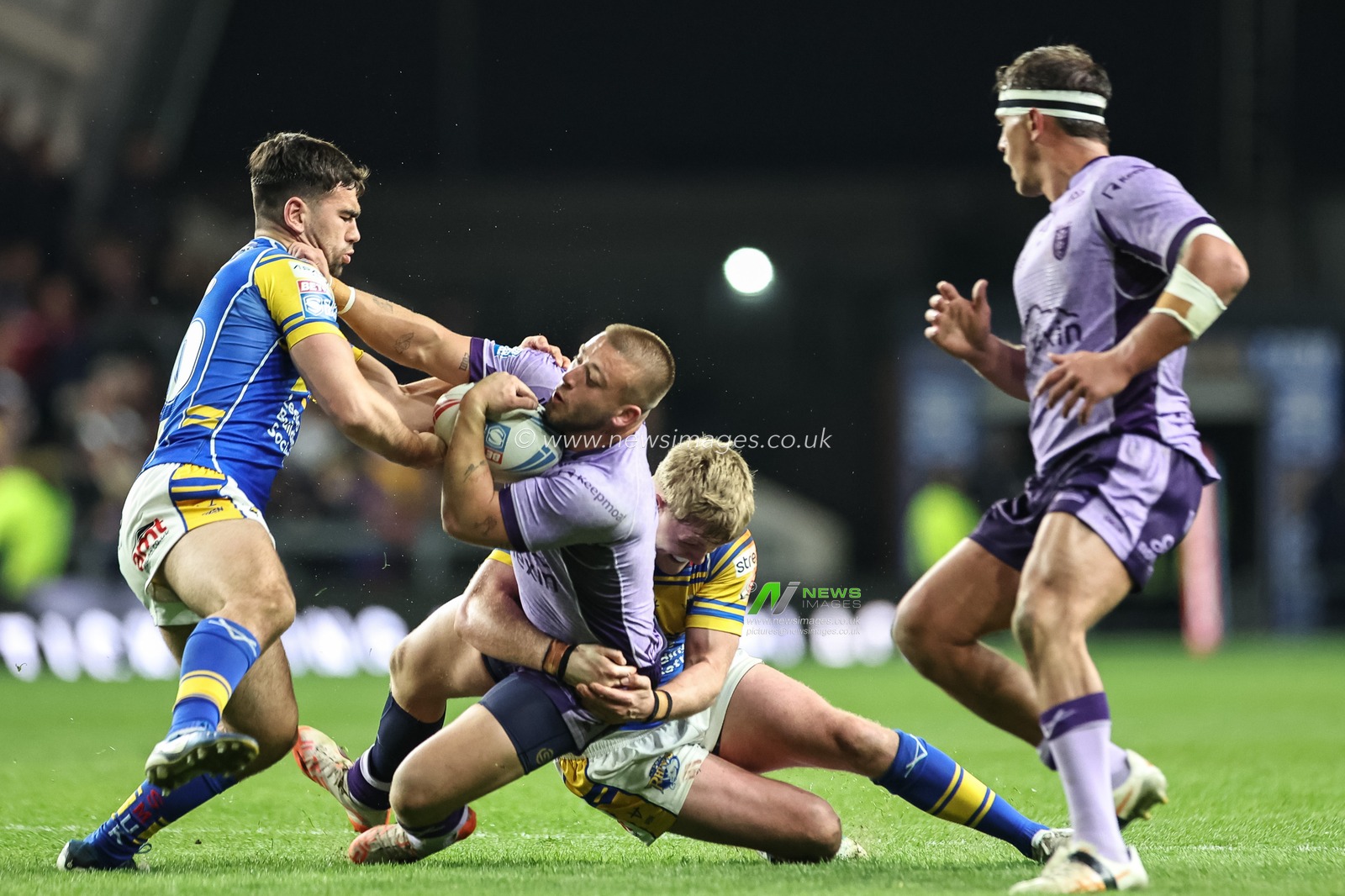 Mikey Lewis of Hull KR is tackled by James McDonnell of Leeds Rhinos and Jack Sinfield of Leeds Rhinos during the Betfred Super League round 9 match Leeds Rhinos vs Hull KR at Headingley Stadium, Leeds, United Kingdom, 25th April 2025

(Photo by Mark Cosgrove/News Images)