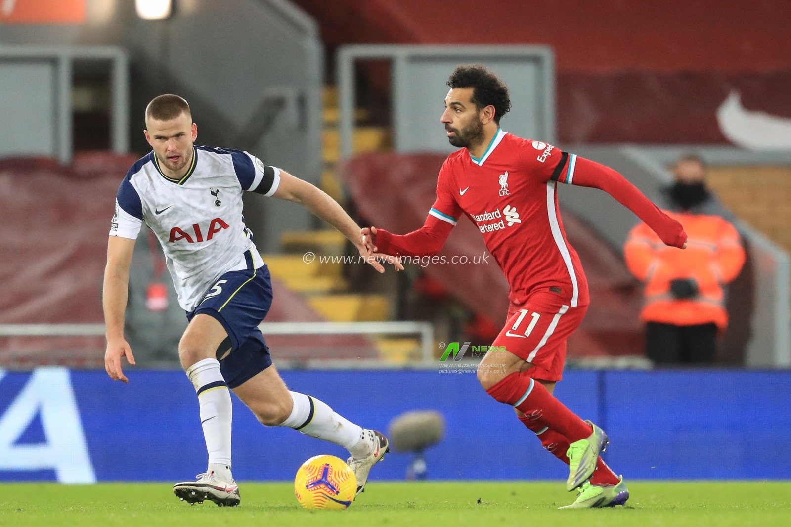 Mohamed Salah #11 of Liverpool breaks as Eric Dier #15 of Tottenham Hotspur tracks him