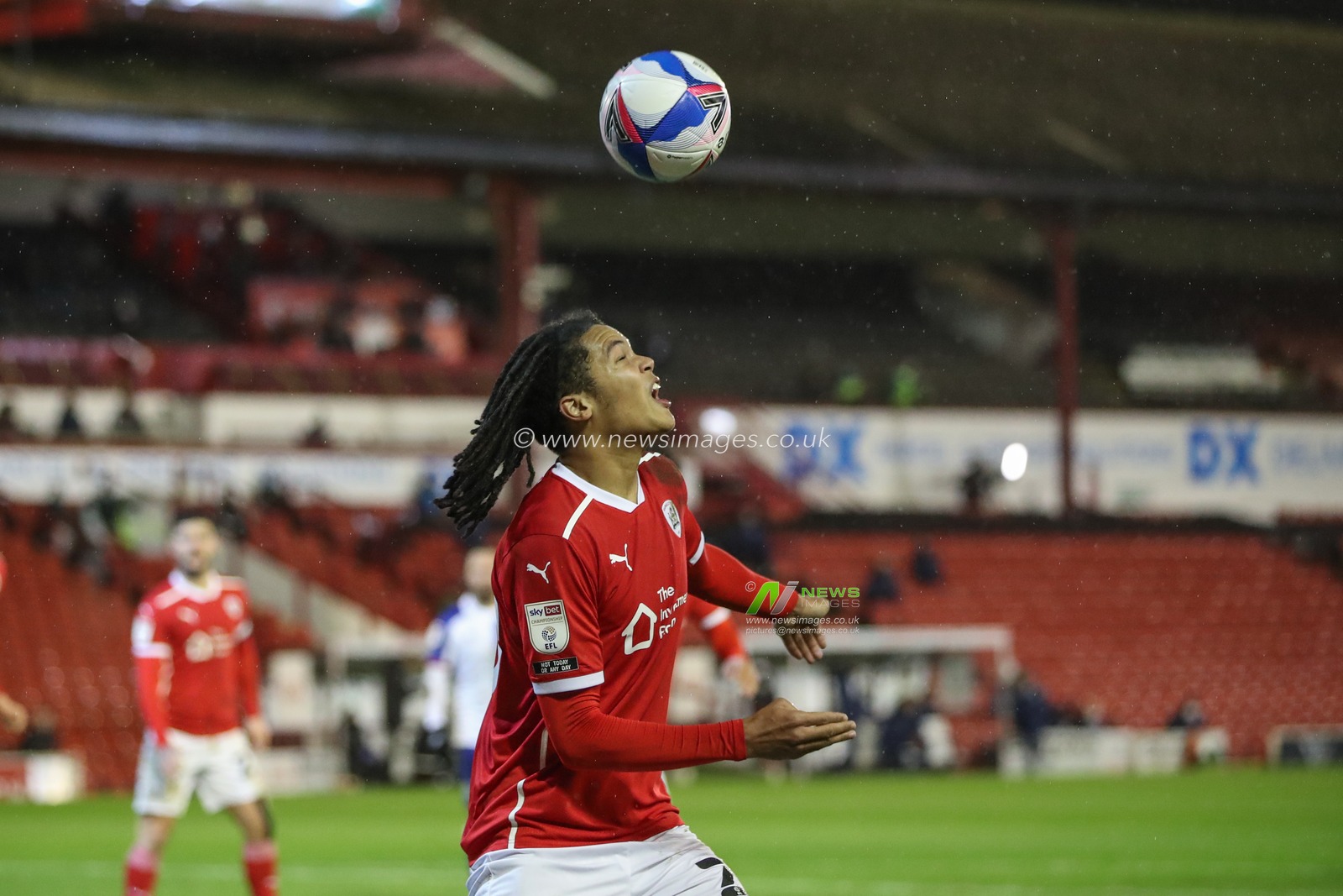 Toby Sibbick #20 of Barnsley heads clear