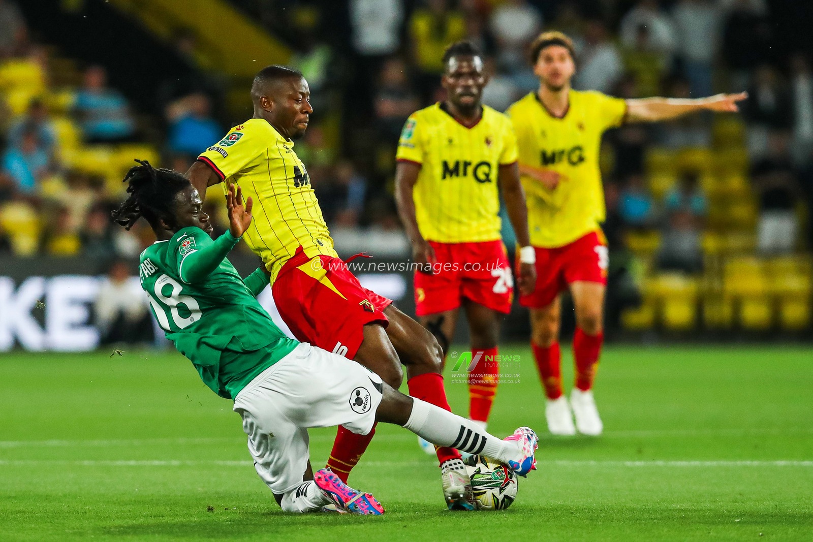 Edo Kayembe of Watford is tackled by Darko Gyabi of Plymouth Argyle during the Carabao Cup match Watford vs Plymouth Argyle at Vicarage Road, Watford, United Kingdom, 27th August 2024

(Photo by Izzy Poles/News Images)