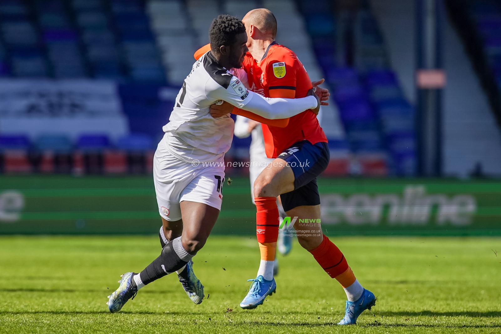 Daryl Dike #10 of Barnsley tangles with Kal Naismith #24 of Luton Town