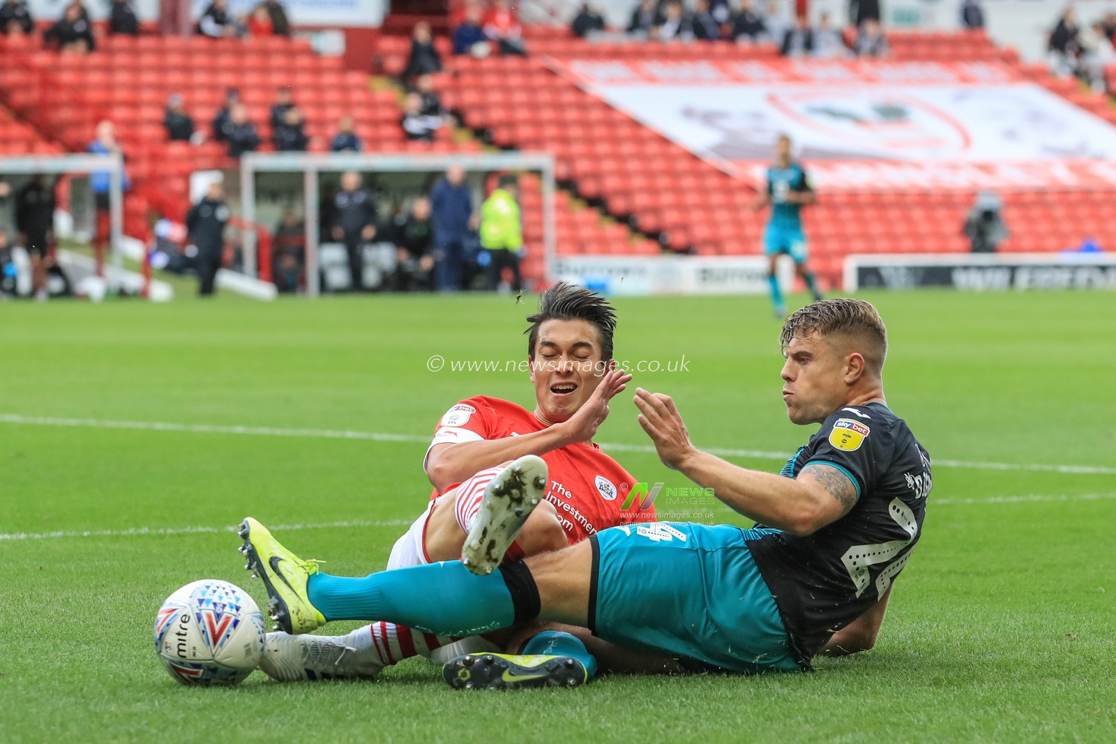 19th October 2019, Oakwell, Barnsley, England; Sky Bet Championship, Barnsley v Swansea City : Kenny Dougall (4) of Barnsley slides in to win the ball from Jake Bidwell (24) of Swansea City 

Credit: Mark Cosgrove/News Images