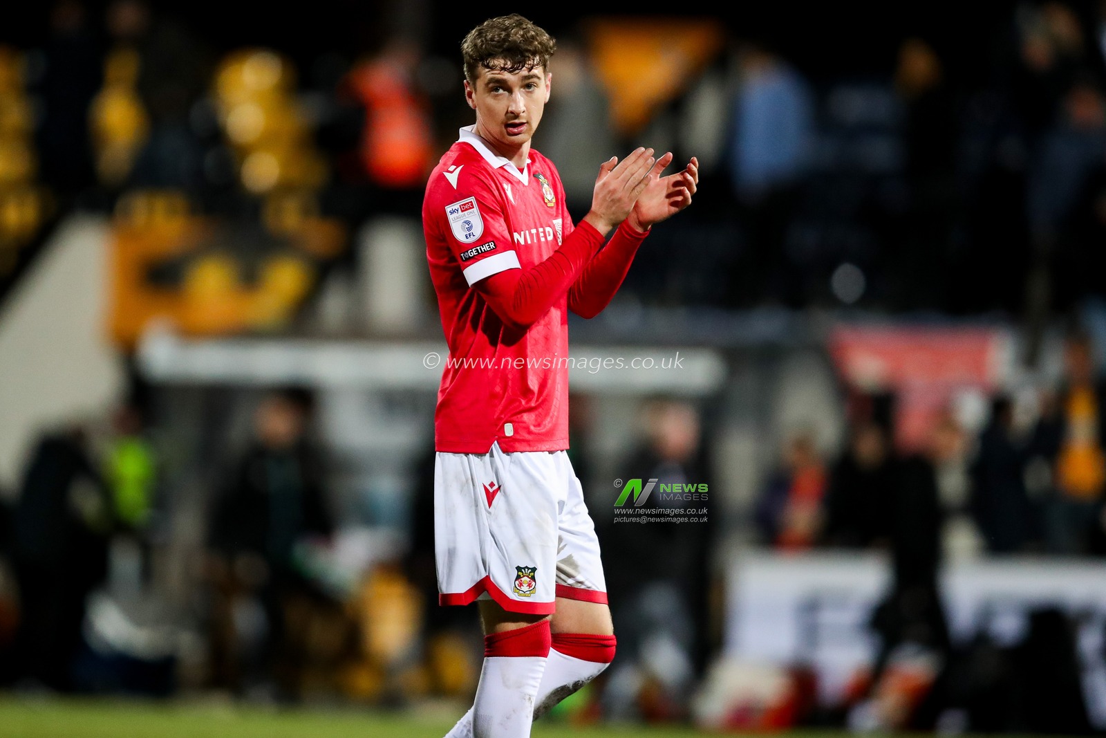 Lewis Brunt of Wrexham AFC acknowledges the fans after the teams draw following the Sky Bet League 1 match Cambridge United vs Wrexham at Abbey Stadium, Cambridge, United Kingdom, 1st April 2025

(Photo by Izzy Poles/News Images)