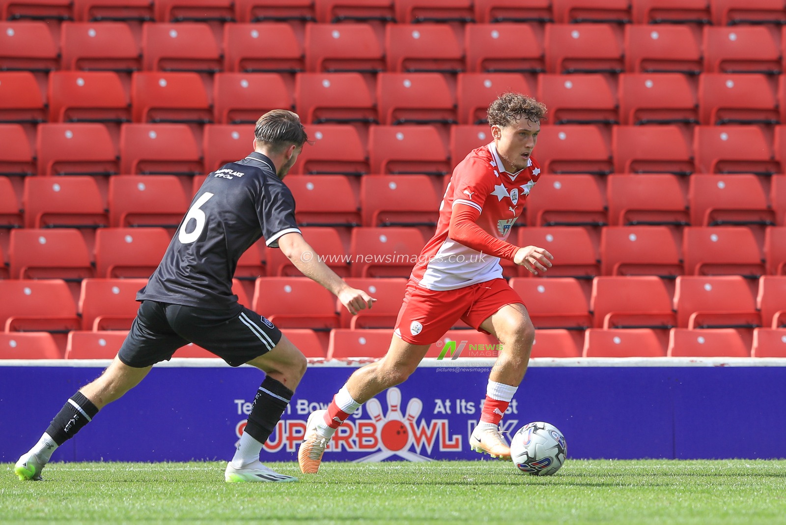 Callum Styles #10 of Barnsley holds the ball as Luke Offord #6 of Crewe Alexandra pressures during the Pre-season friendly match Barnsley vs Crewe Alexandra at Oakwell, Barnsley, United Kingdom, 29th July 2023

(Photo by Alfie Cosgrove/News Images)