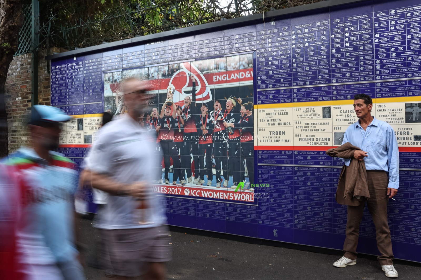 Spectators walk past the ICC Women’s World Cup mural during the 3rd Rothesay Test Match Day 1 England v India at Lords, London, United Kingdom, 10th July 2025

(Photo by Mark Cosgrove/News Images)
