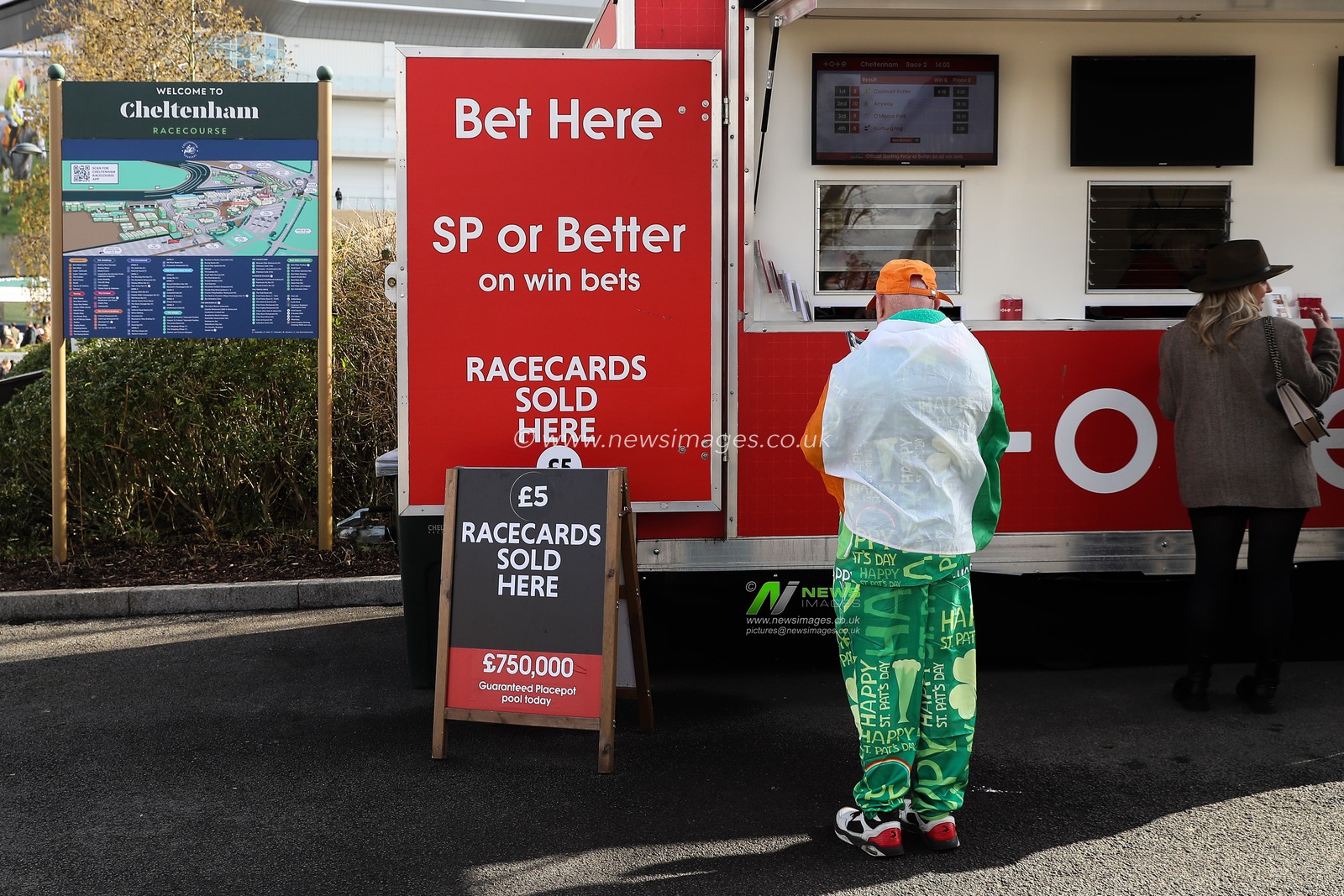 A racegoer with an Irish flag on his back places a bet during the Cheltenham Festival 2025 St Patrickâ€™s Thursday at Cheltenham Racecourse, Cheltenham, United Kingdom, 13th March 2025

(Photo by Gareth Evans/News Images)