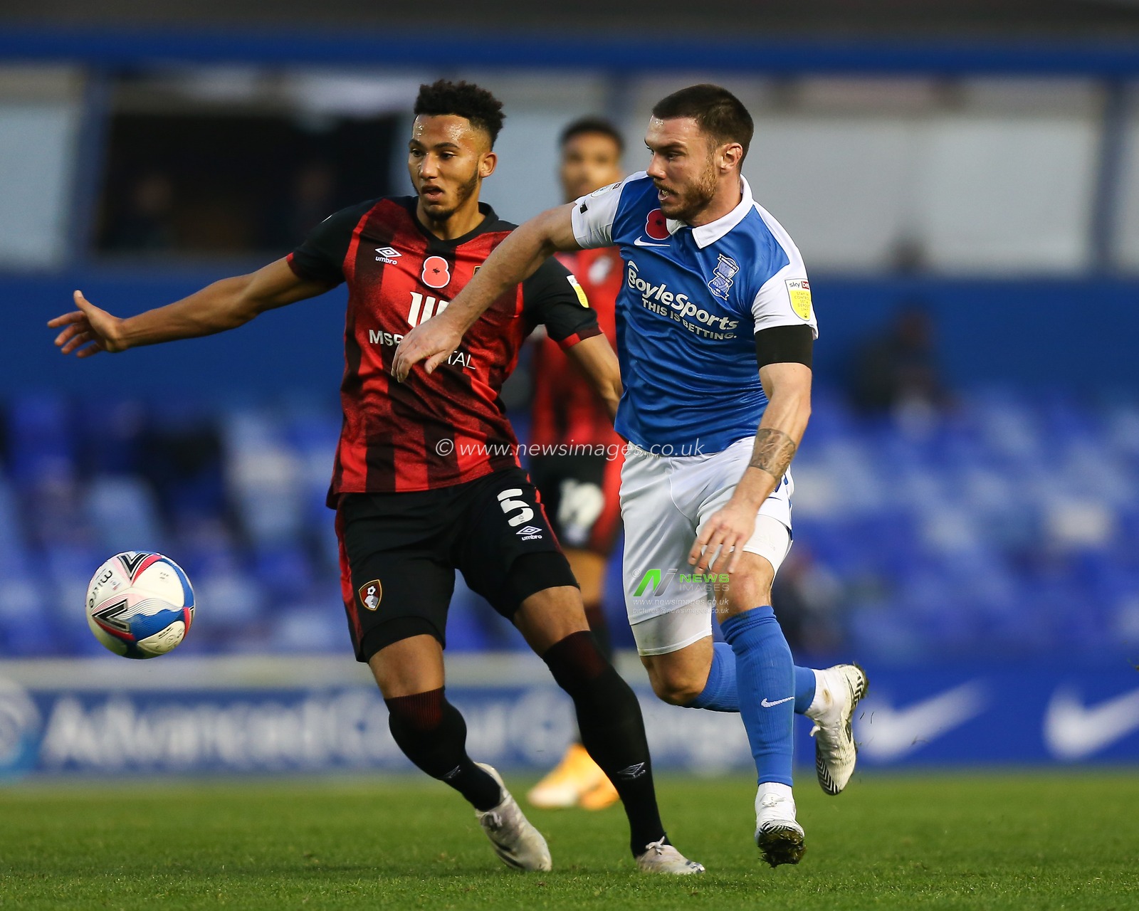 Scott Hogan #9 of Birmingham City competes for the ball with Lloyd Kelly #5 of Bournemouth