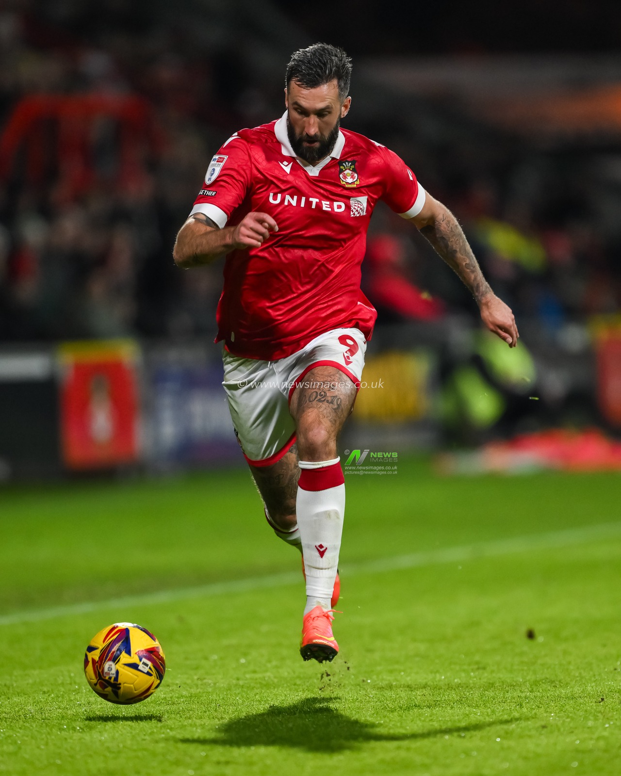 Ollie Palmer of Wrexham makes a break with the ball  during the Sky Bet League 1 match Wrexham vs Barnsley at SToK Cae Ras, Wrexham, United Kingdom, 3rd December 2024

(Photo by Craig Thomas/News Images)