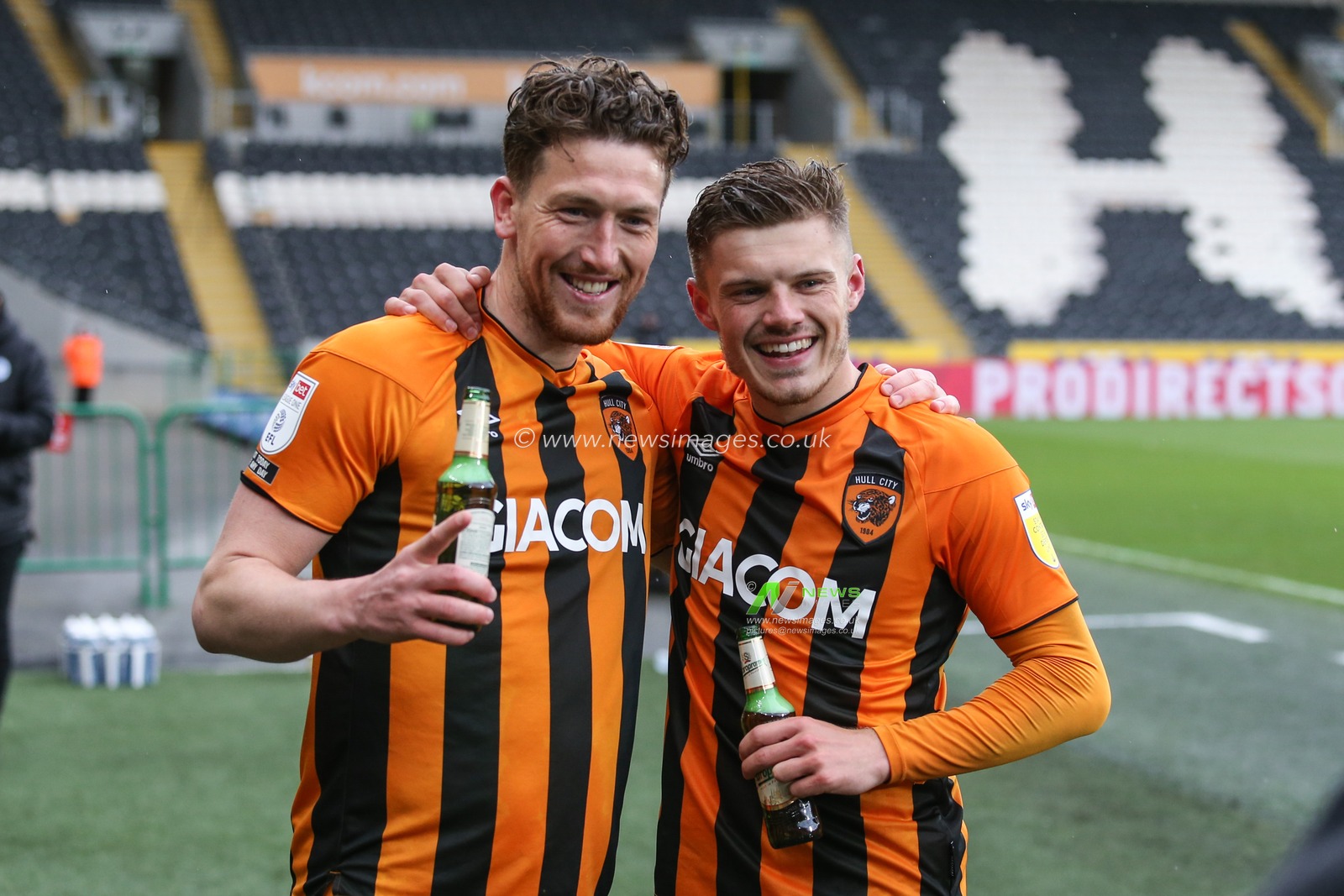 Richard Smallwood #6 and Regan Slater #18 of Hull City celebrate with a beer after the final whistle