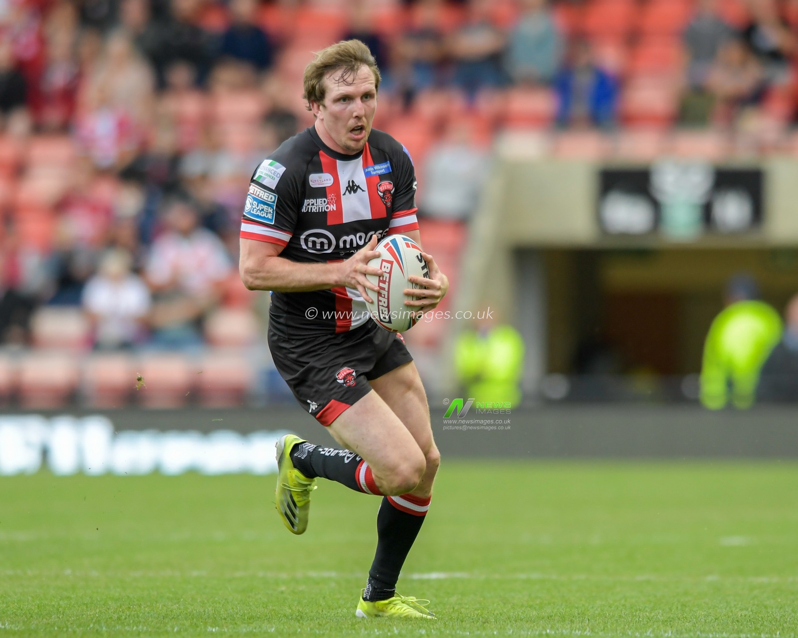 Dan Sarginson (23) of Salford Red Devils runs forward with the ball