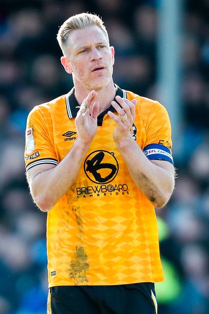 Michael Morrison of Cambridge United acknowledges the fans after the teams defeat following the Sky Bet League 1 match Cambridge United vs Peterborough United at Cledara Abbey Stadium, Cambridge, United Kingdom, 15th March 2025

(Photo by Izzy Poles/News Images)