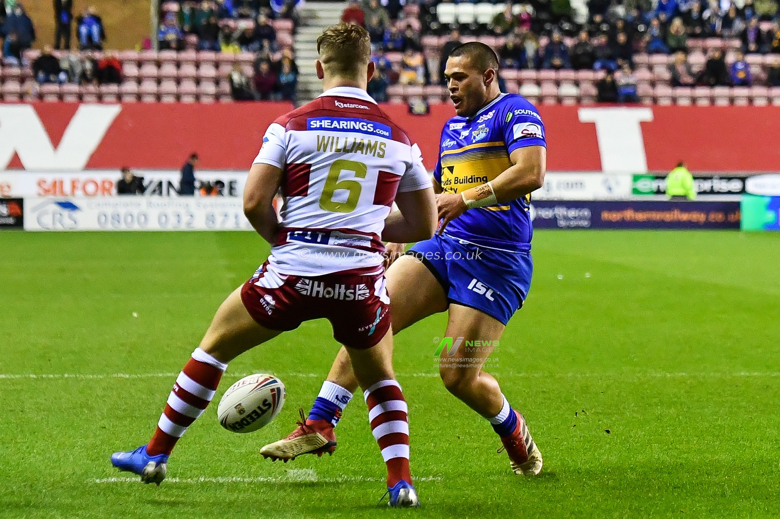 8th February  2019 , DW Stadium, Wigan, England;  Betfred Super League, Round 2, Wigan Warriors vs Leeds Rhinos ; Tui Lolohea (6) of Leeds Rhinos kicks ahead

Credit: Craig Thomas/News Images
