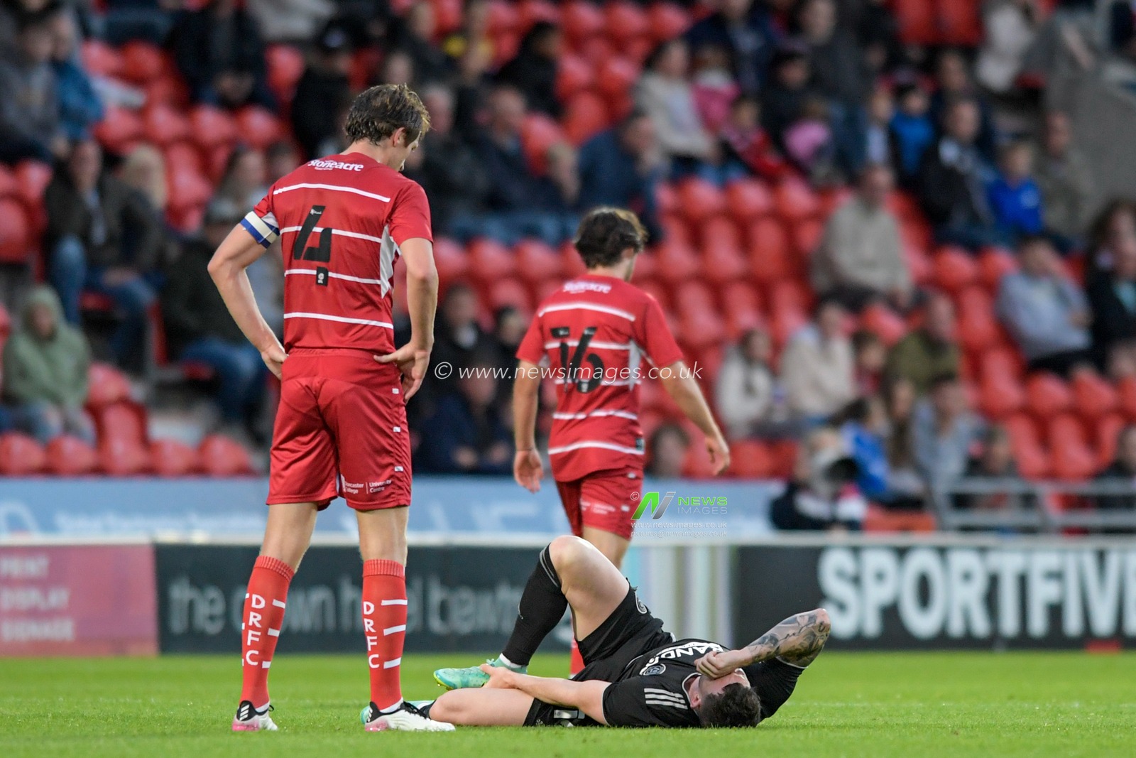 Oliver Burke #14 of Sheffield United holds his ankle after picking up an injury