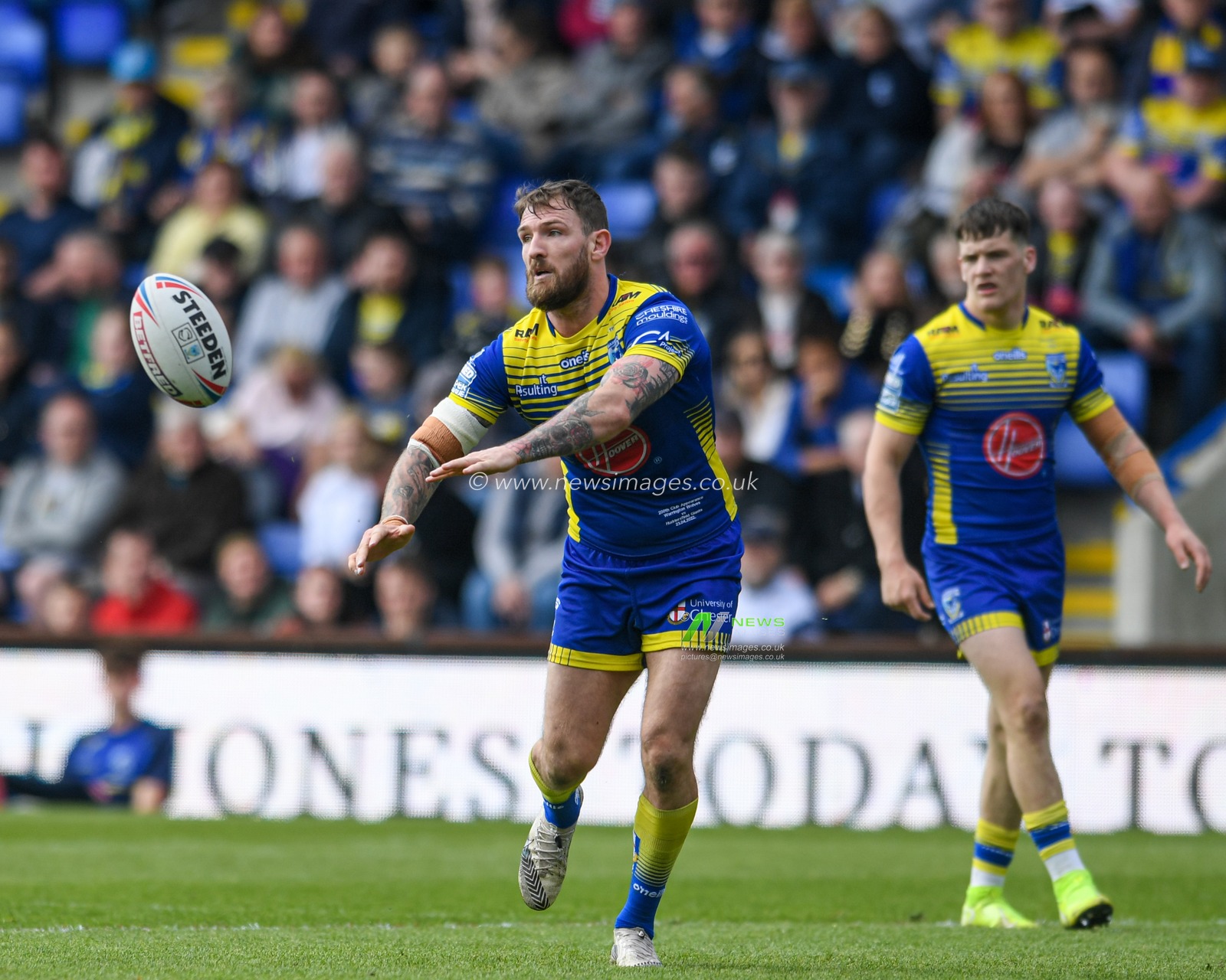 Daryl Clark #9 of Warrington Wolves passes the ball