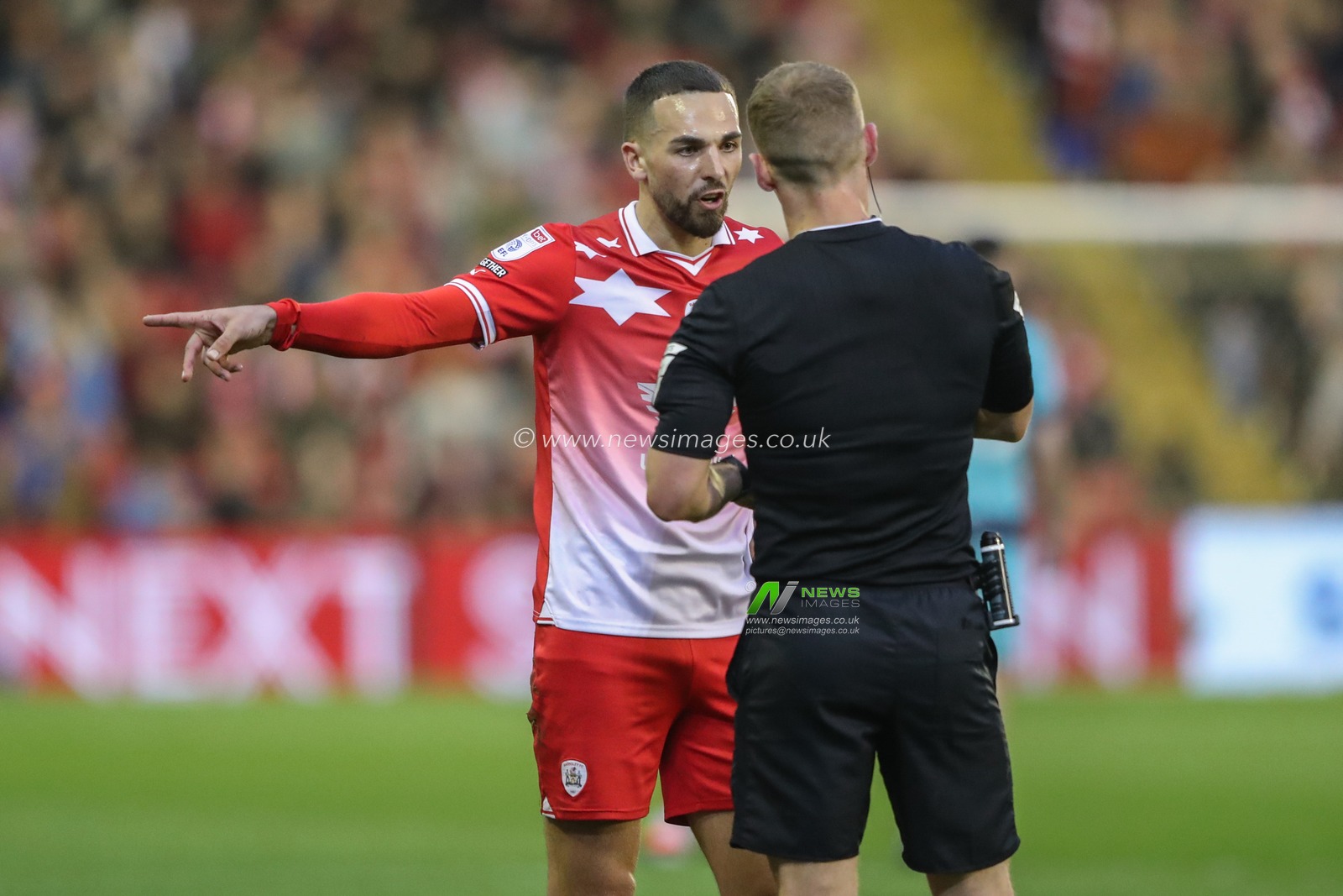 Adam Phillips of Barnsley speaks to referee Will Finnie after he gives a free kick to Bolton during the Sky Bet League 1 Sky Bet League 1 Promotion Play-offs Semi-final first leg match Barnsley vs Bolton Wanderers at Oakwell, Barnsley, United Kingdom, 3rd May 2024

(Photo by Alfie Cosgrove/News Images)