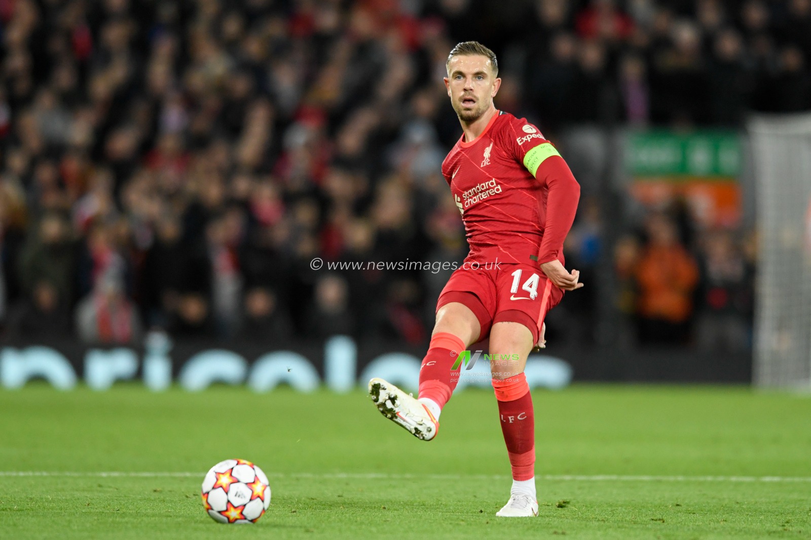 Jordan Henderson #14 of Liverpool passes the ball