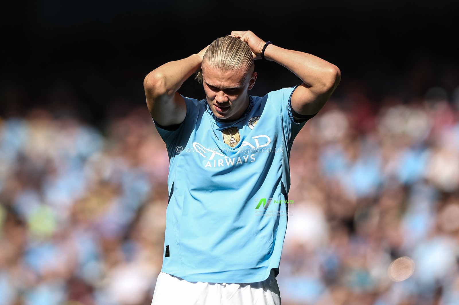 Erling Haaland of Manchester City ties his hair up during the Premier League match Manchester City vs Ipswich Town at Etihad Stadium, Manchester, United Kingdom, 24th August 2024

(Photo by Mark Cosgrove/News Images)