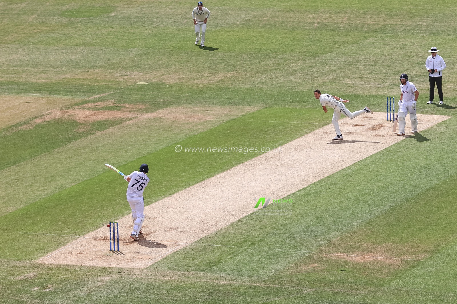 Jamie Overton of England clips the ball and is caught behind by Daryl Mitchell of New Zealand, out for 97