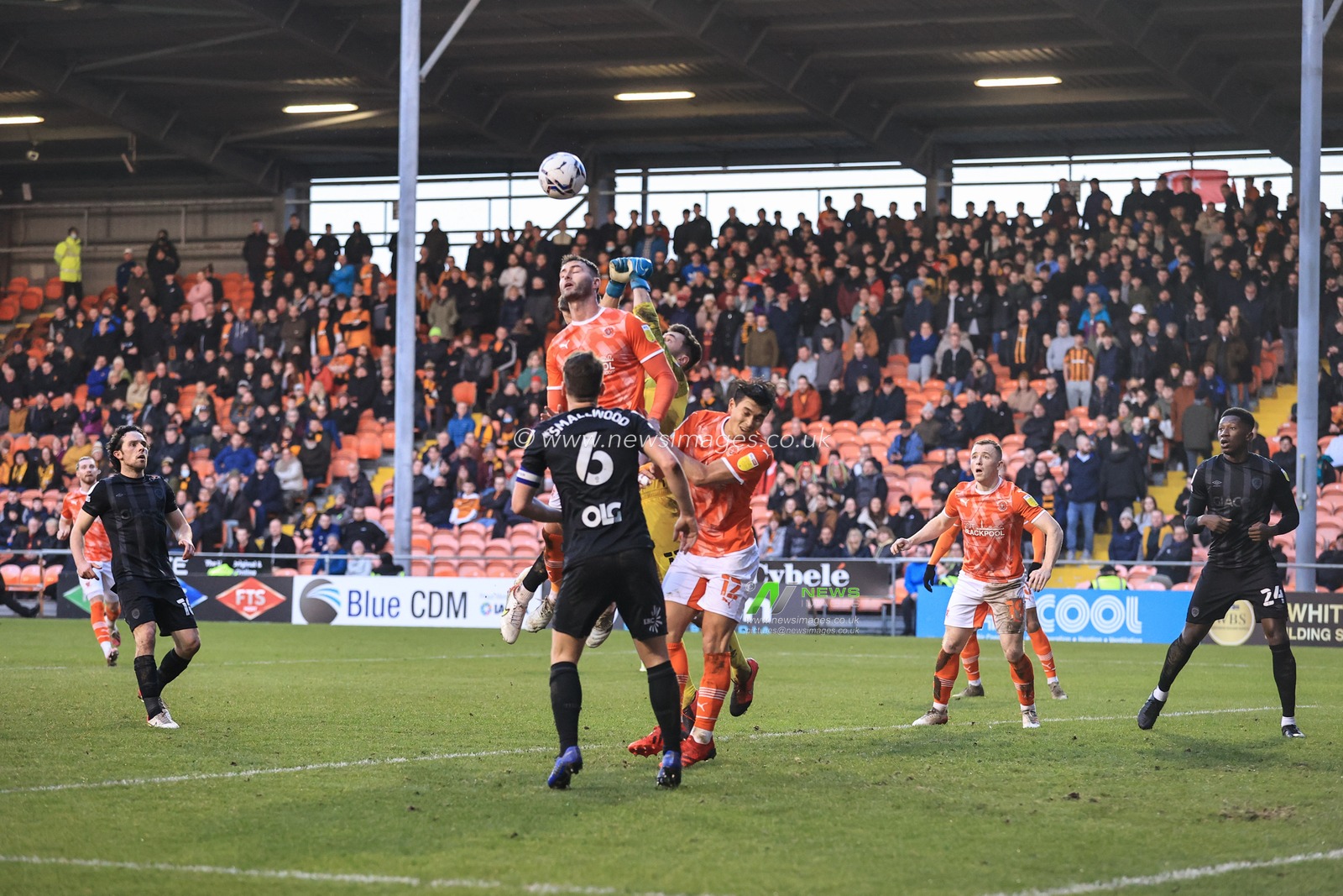 Gary Madine #14 of Blackpool and Nathan Baxter #13 of Hull City battle for the ball