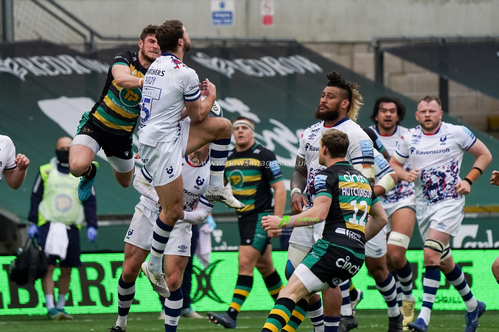 James Grayson #10 of Northampton Saints and  Henry Purdy #15 of Bristol Rugby battle in mid air