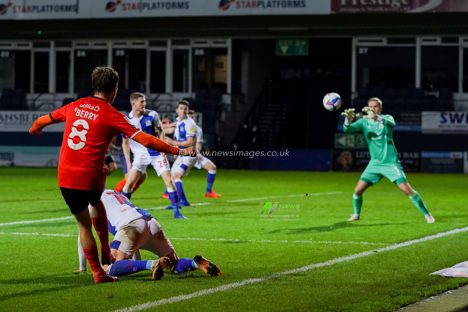 Luke Berry #8 of Luton Town crosses the ball into danger