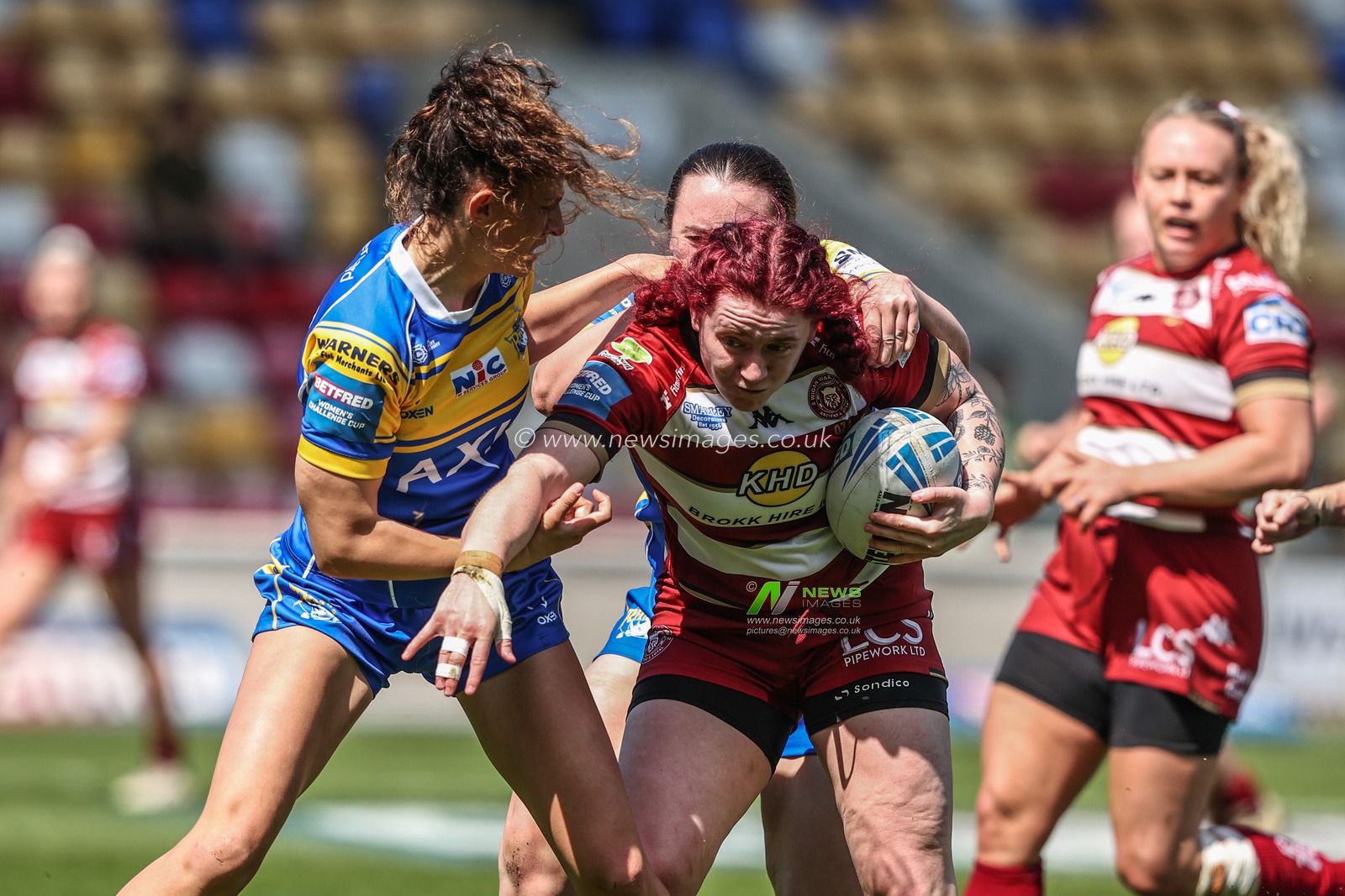 Eva Hunter of Wigan Warriors is tackled during the Betfred Women's Challenge Cup Cup Semi-final match Leeds Rhinos vs Wigan Warriors at LNER Community Stadium, York, United Kingdom, 10th May 2025

(Photo by Alfie Cosgrove/News Images)