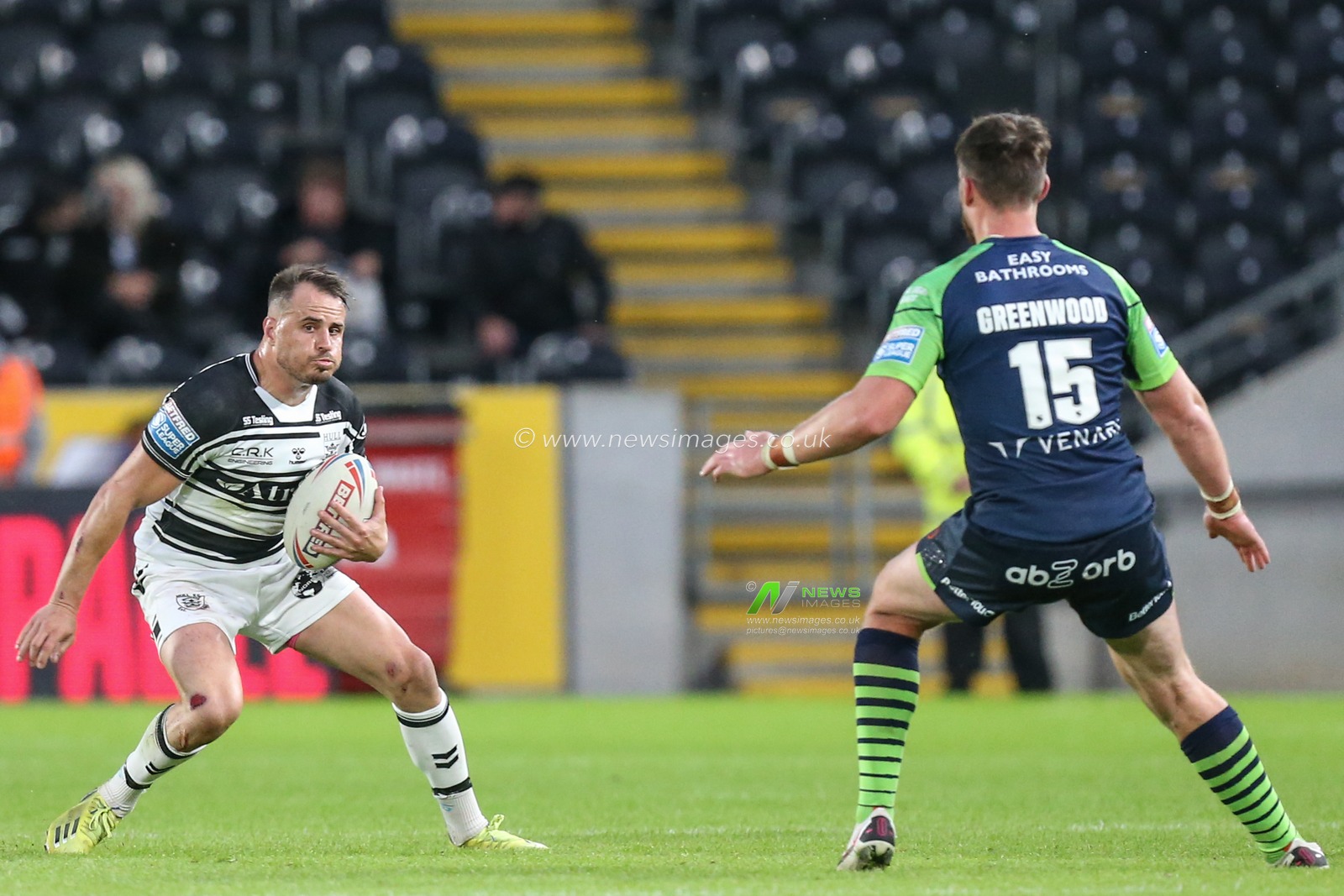 Josh Reynolds (6) of Hull FC looks to get past Joe Greenwood (15) of Huddersfield Giants