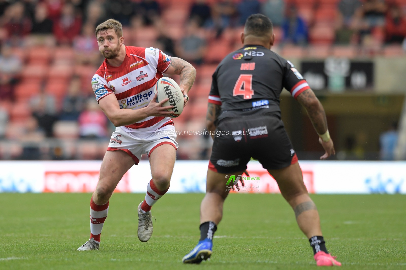 Ben Hellewell (11) of Leigh Centurions looks for a way past Krisnan Inu (4) of Salford Red Devils