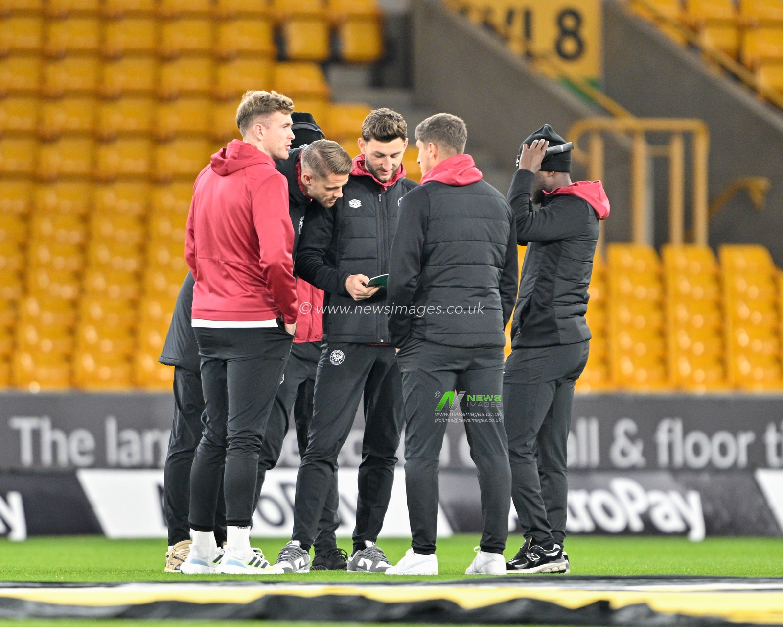 Brentford players check over the match day program as they inspects the pitch ahead of the match, during the Emirates FA Cup Third Round Replay match Wolverhampton Wanderers vs Brentford at Molineux, Wolverhampton, United Kingdom, 16th January 2024

(Photo by Cody Froggatt/News Images)
