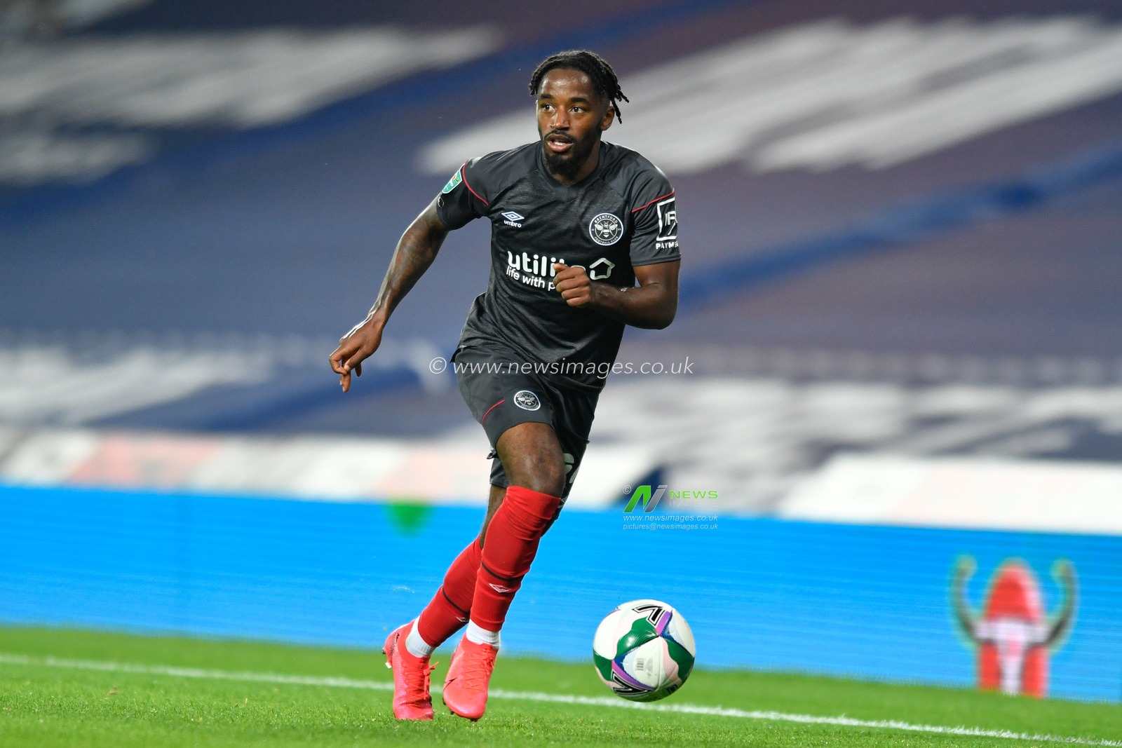 Tariqe Fosu (24) of Brentford runs forward with the ball