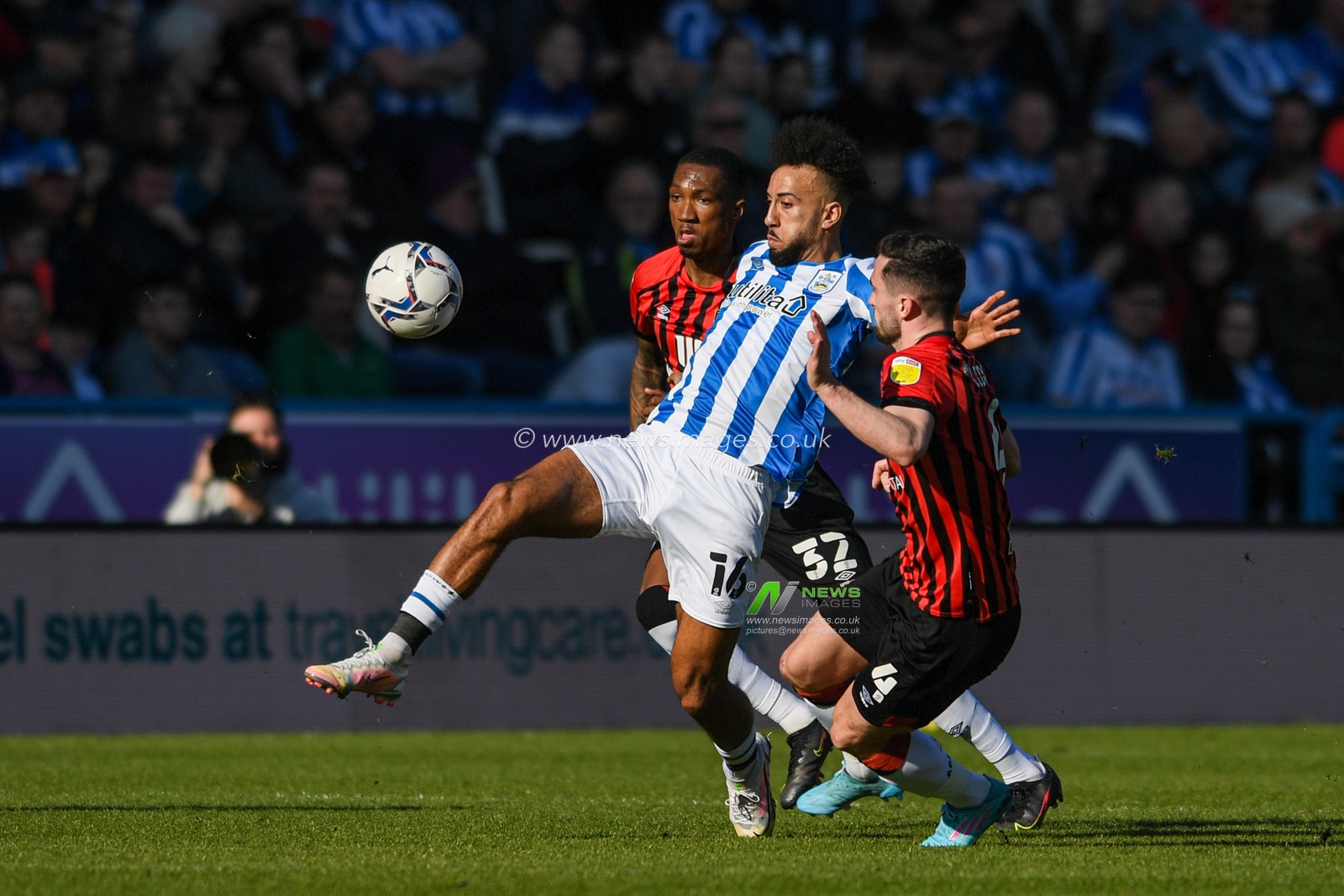 Sorba Thomas #16 of Huddersfield Town attempts to control the ball