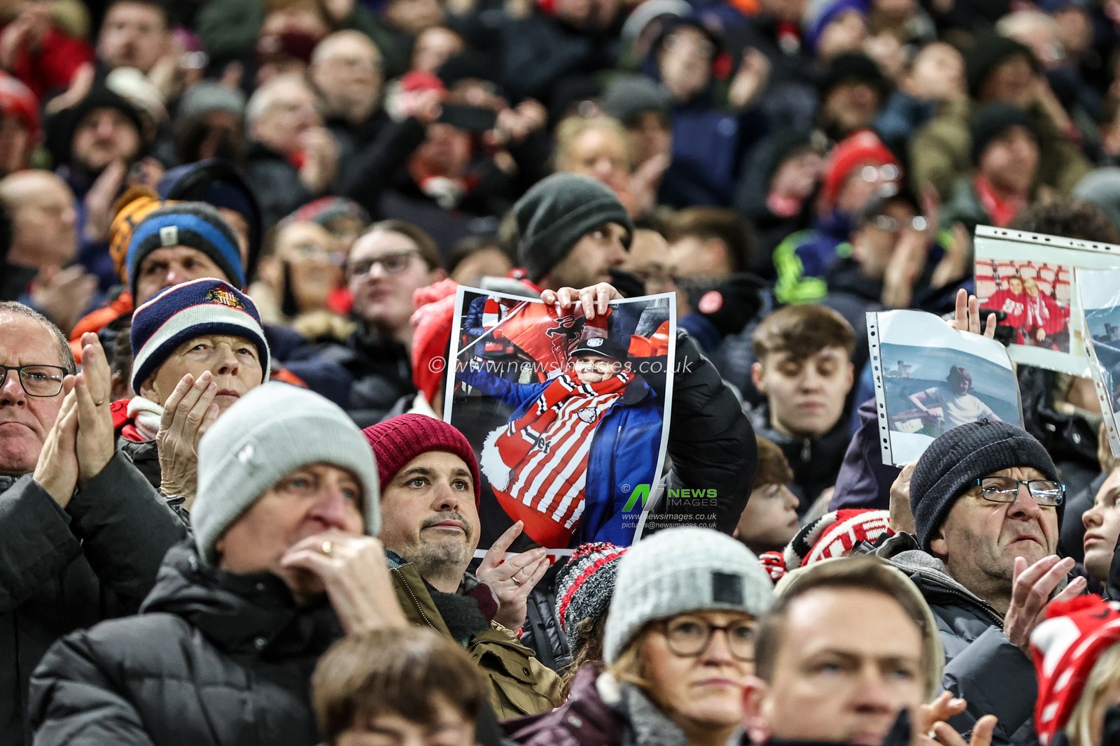 Sunderland fans hold up pictures of loved ones on remembrance fixture during the Premier League match Sunderland vs Manchester City at Stadium Of Light, Sunderland, United Kingdom, 1st January 2026

(Photo by Alfie Cosgrove/News Images)

*** GER AUT SUI OUT ***