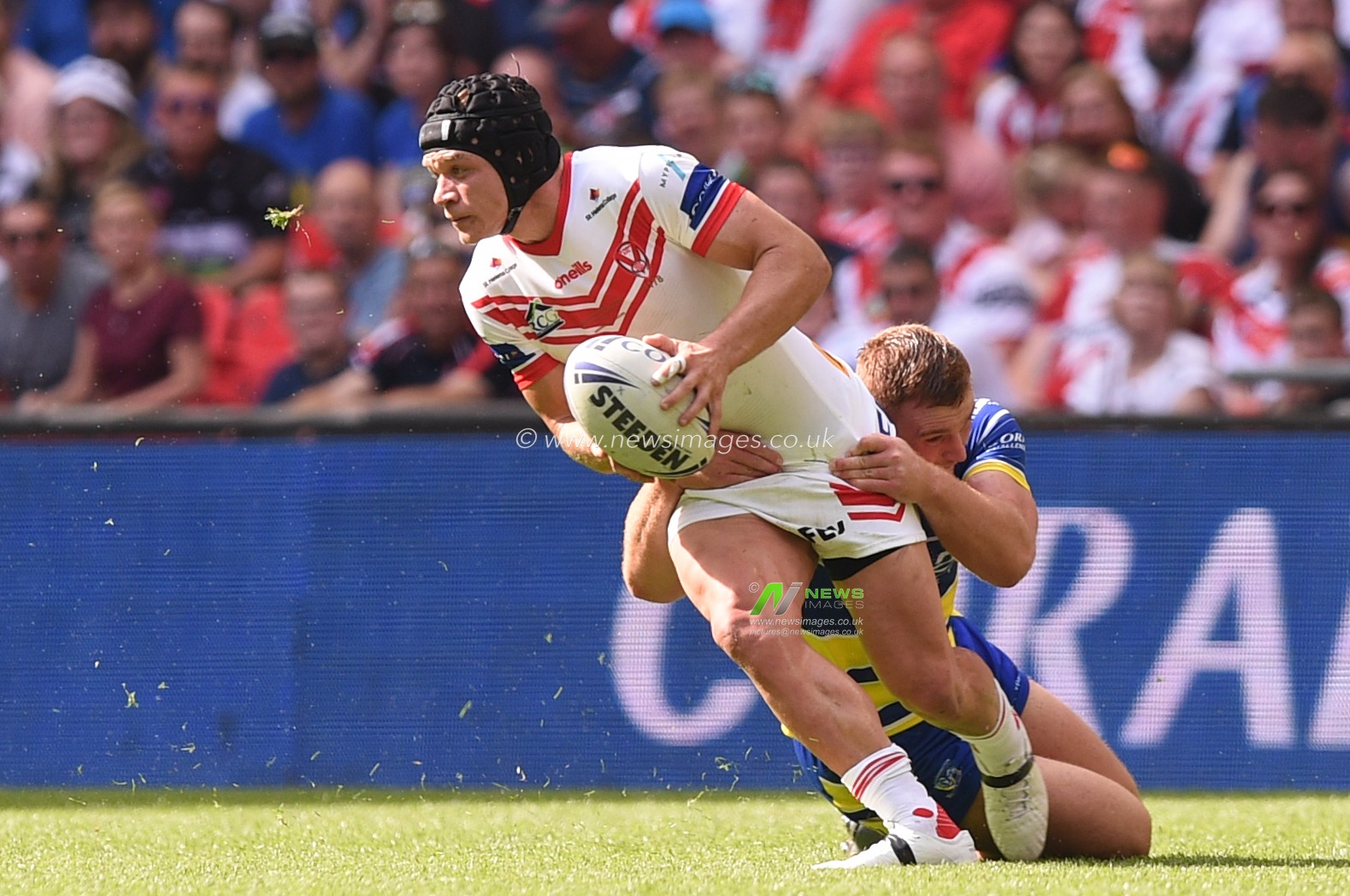 24th August 2019 , Wembley Stadium, London England ; 2019 Coral Challenge Cup Final ; St Helens vs Warrington Wolves ; Jonny Lomax of St Helens is tackled by Jack Hughes of Warrington Wolves 



Credit: Richard Long/News Images