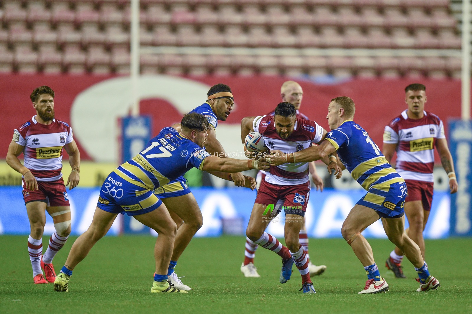 16th August 2019 , DW Stadium, Wigan, England;  Betfred Super League, Round 26, Wigan Warriors vs Warrington Wolves ; Bevan French of Wigan Warriors is tackled by Joe Philbin of Warrington Wolves and Ben Currie of Warrington Wolves 

Credit: Richard Long/News Images