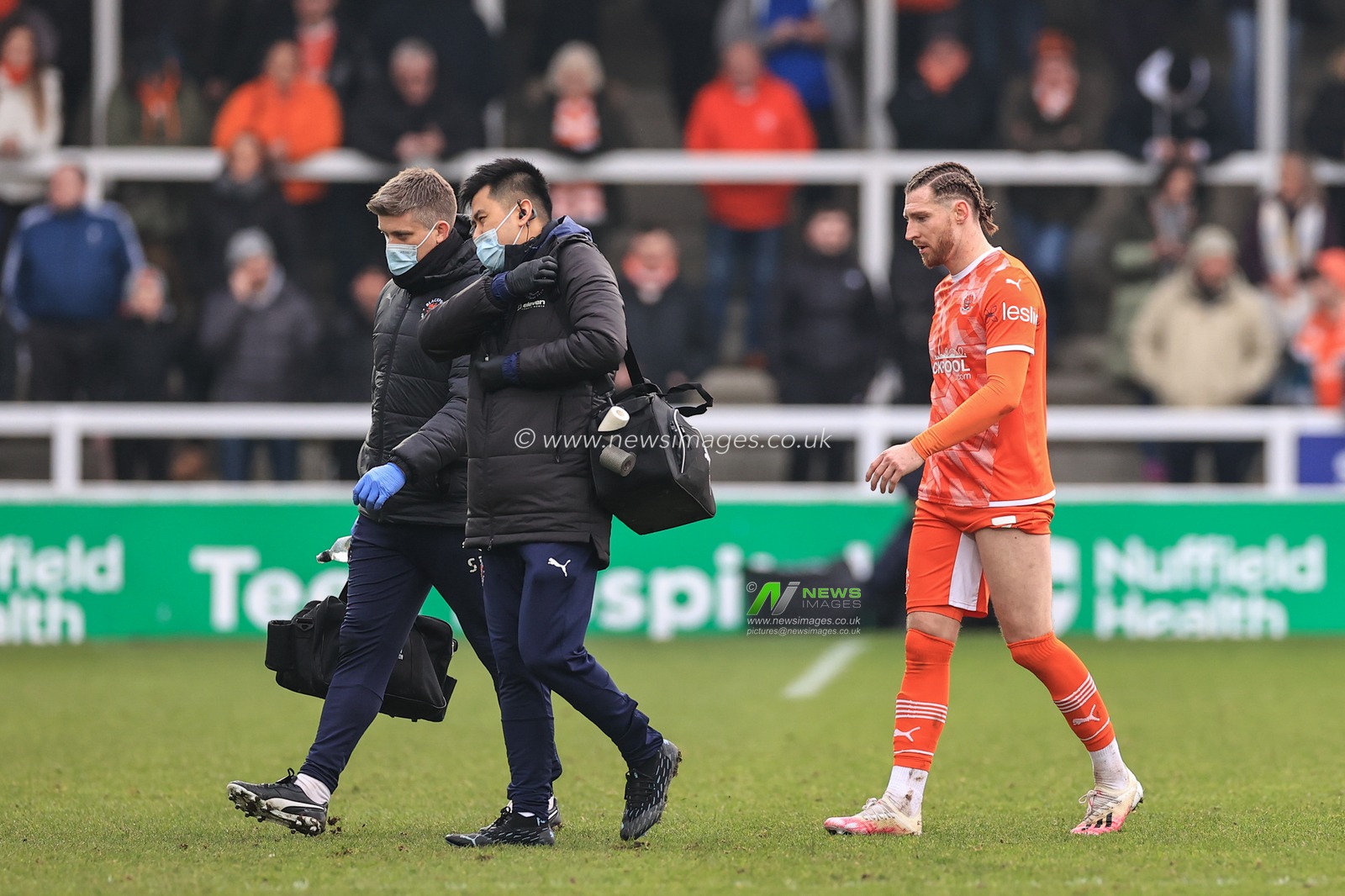 James Husband #3 of Blackpool leaves the field injured