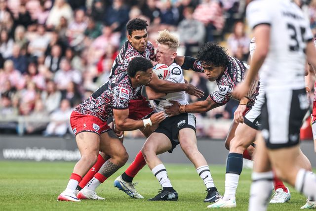 Lloyd Kemp of Hull FC is tackled by Jacob Alick-Wiencke of Leigh Leopards and Joe Ofahengaue of Leigh Leopards during the Betfred Super League round 12 match Leigh Leopards vs Hull FC at Leigh Sports Village, Leigh, United Kingdom on 22 May 2026

(Photo by Alfie Cosgrove/News Images)