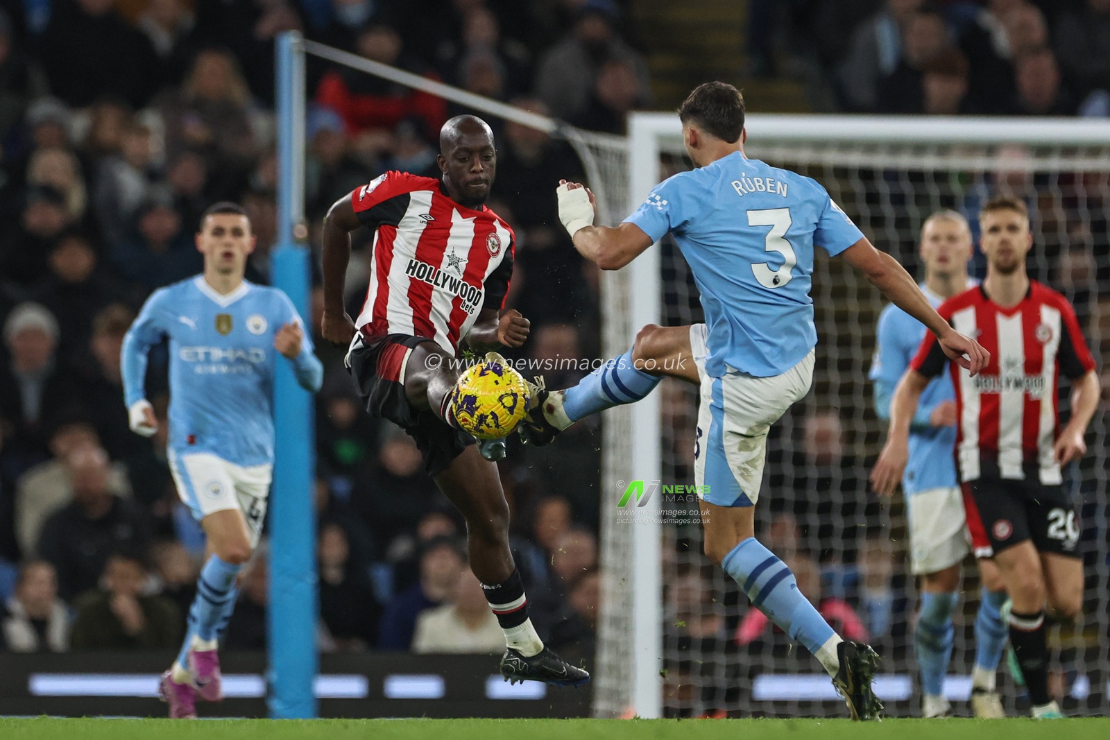 Yoane Wissa of Brentford fouls RÃºben Dias of Manchester City as they battle for the ball during the Premier League match Manchester City vs Brentford at Etihad Stadium, Manchester, United Kingdom, 20th February 2024

(Photo by Mark Cosgrove/News Images)