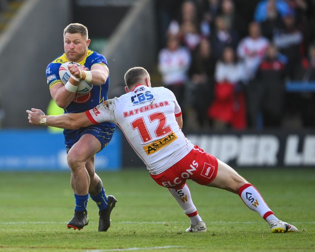 John Bateman of Warrington Wolves is tackled by Joe Batchelor of St. Helens during the Betfred Super League play-off Eliminator 2 Warrington Wolves v St Helens at Halliwell Jones Stadium, Warrington, United Kingdom, 28th September 2024

(Photo by Craig Thomas/News Images)