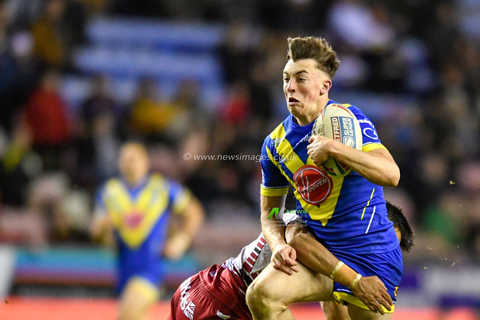 30th January 2020, DW Stadium, Wigan, England; Betfred Super League, Wigan Warriors v Warrington Wolves : Matty Ashton (26) of Warrington Wolves attempts to break through a tackle