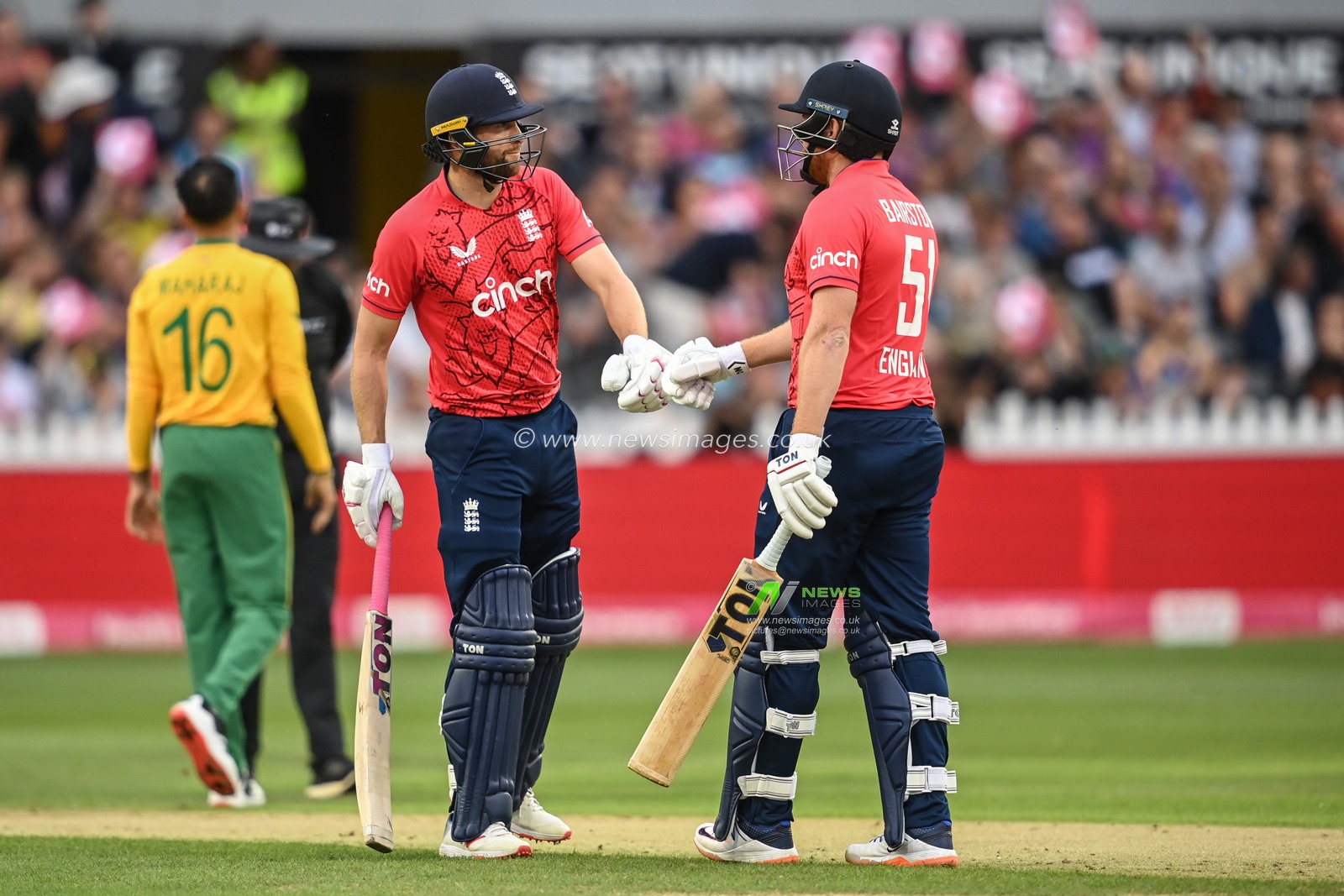 Jonny Bairstow of England celebrates his six with Dawid Malan of England