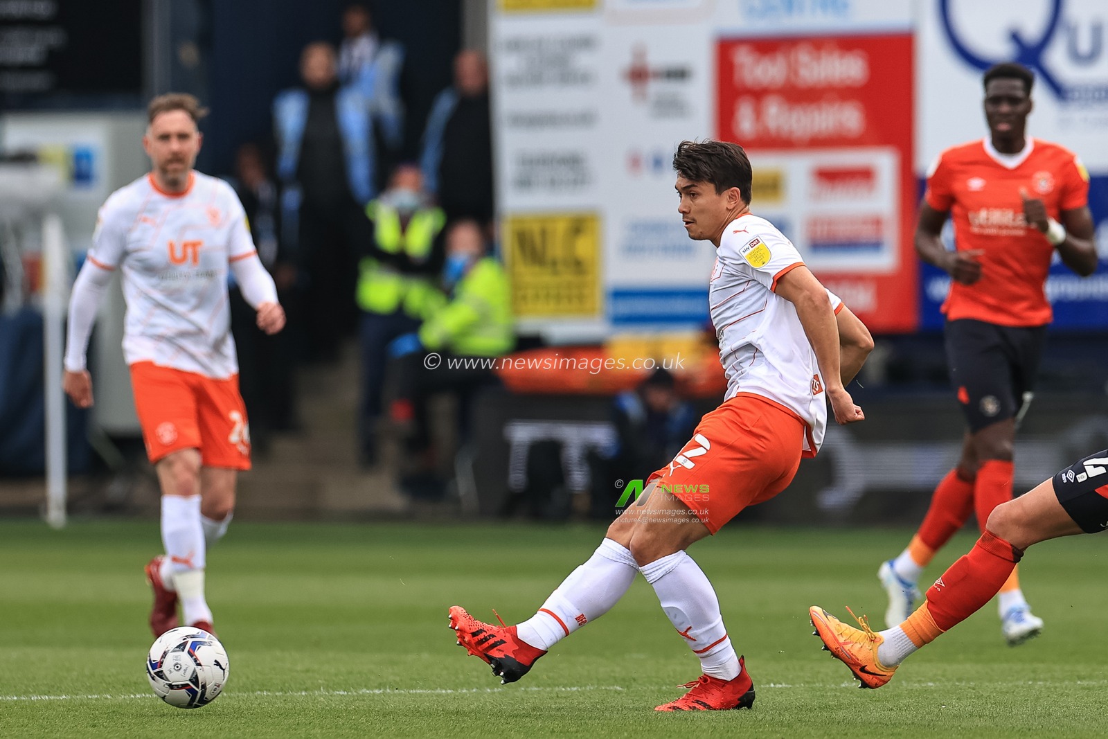 Kenny Dougall #12 of Blackpool passes the ball