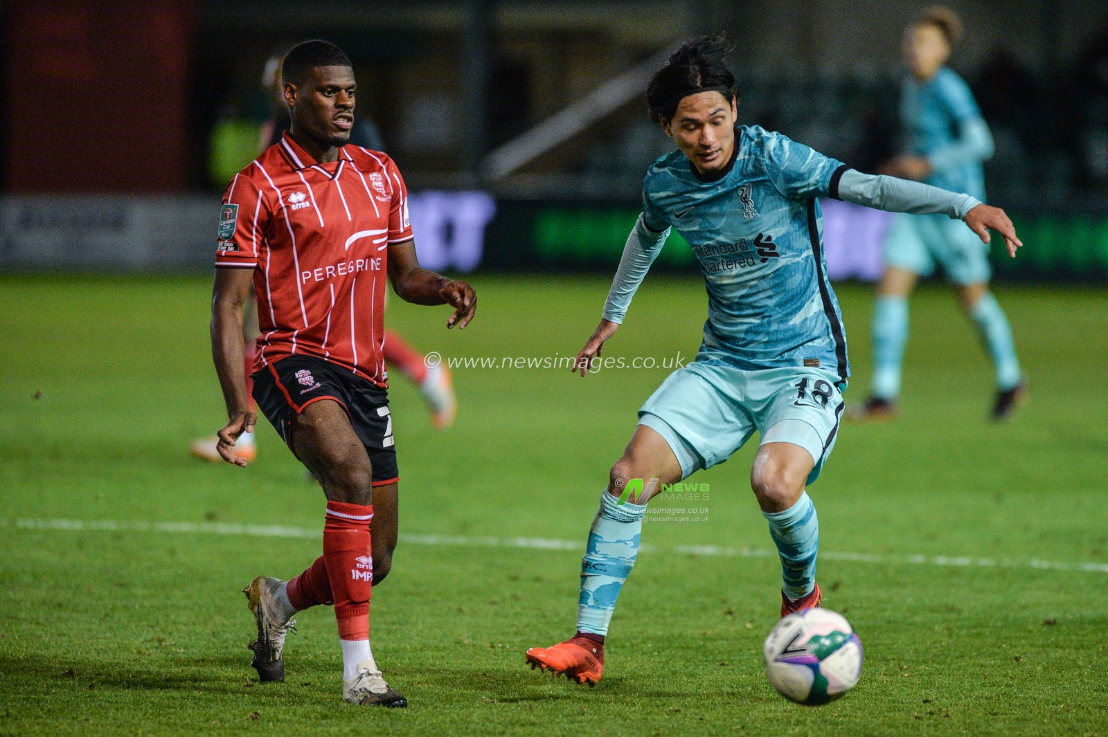 Takumi Minamino (18) of Liverpool in action.