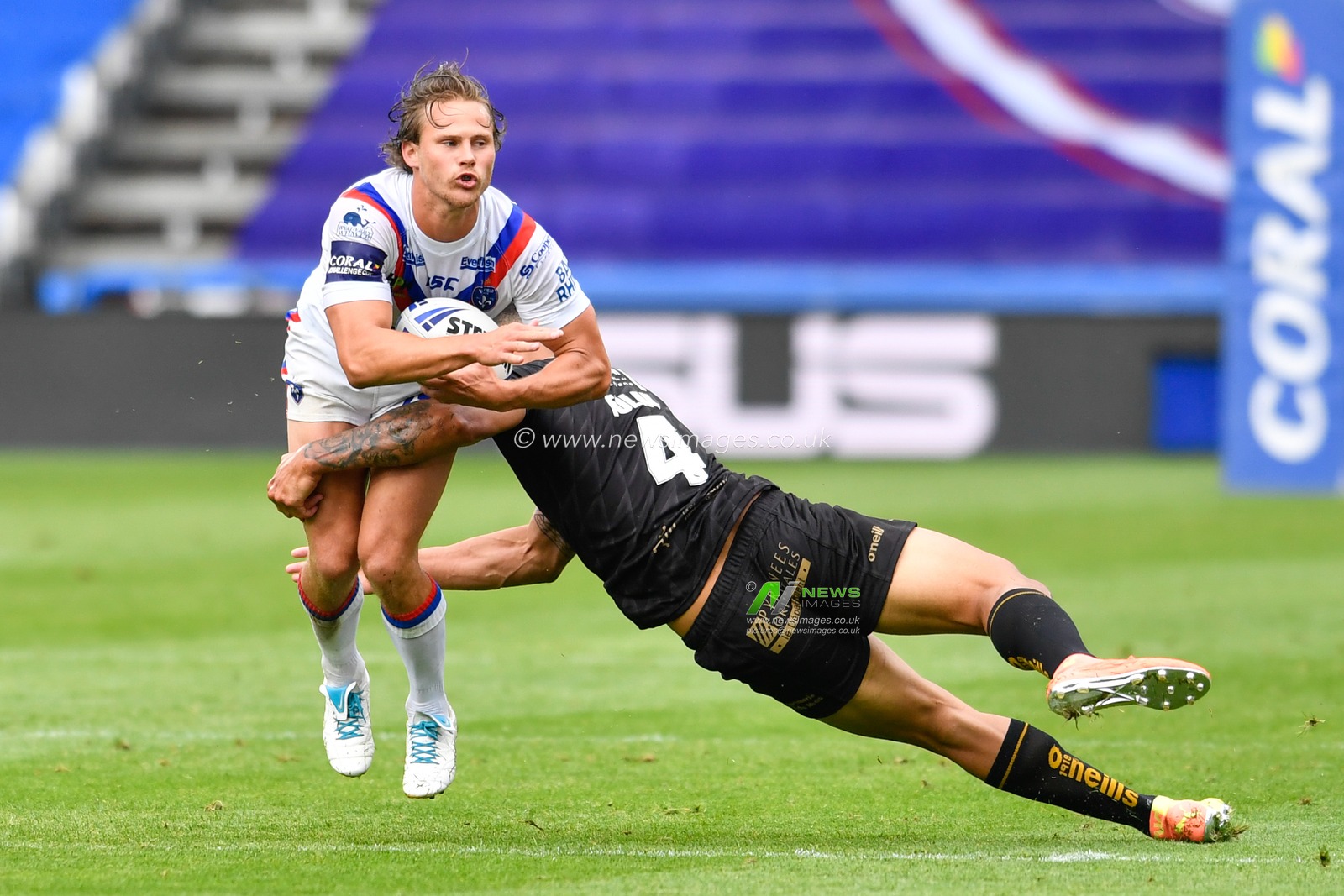 Jacob Miller (6) of Wakefield Trinity is tackled by Israel Folau (4) of Catalans Dragons