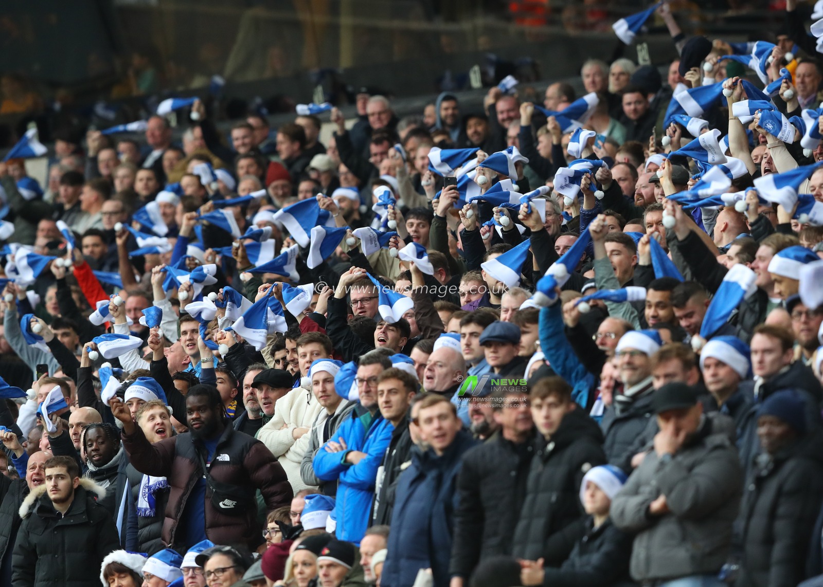 Chelsea fan twirl their hats, during the Premier League match Wolverhampton Wanderers vs Chelsea at Molineux, Wolverhampton, United Kingdom, 24th December 2023

(Photo by Gareth Evans/News Images)